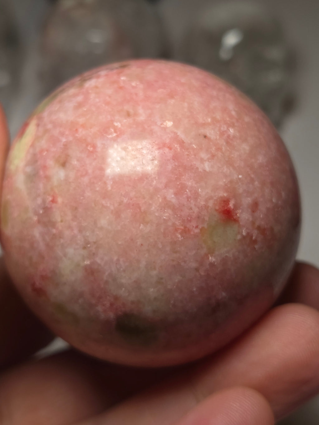 Pink zoisite crystal sphere carving with UV and comes with Stand