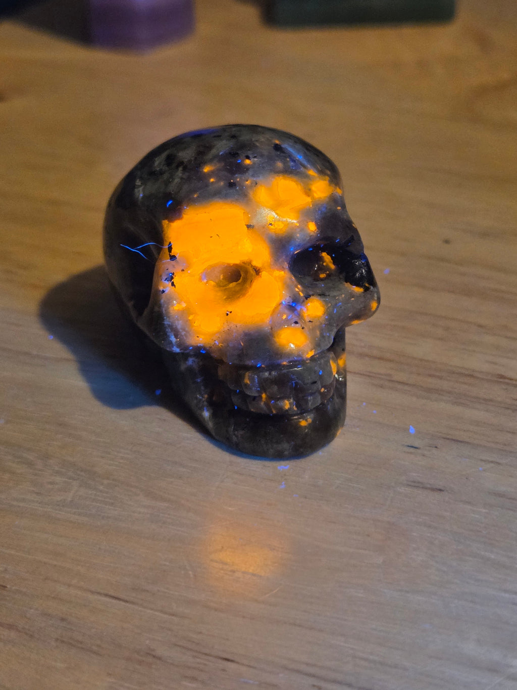 Yooperlite crystal skull carving with orange uv