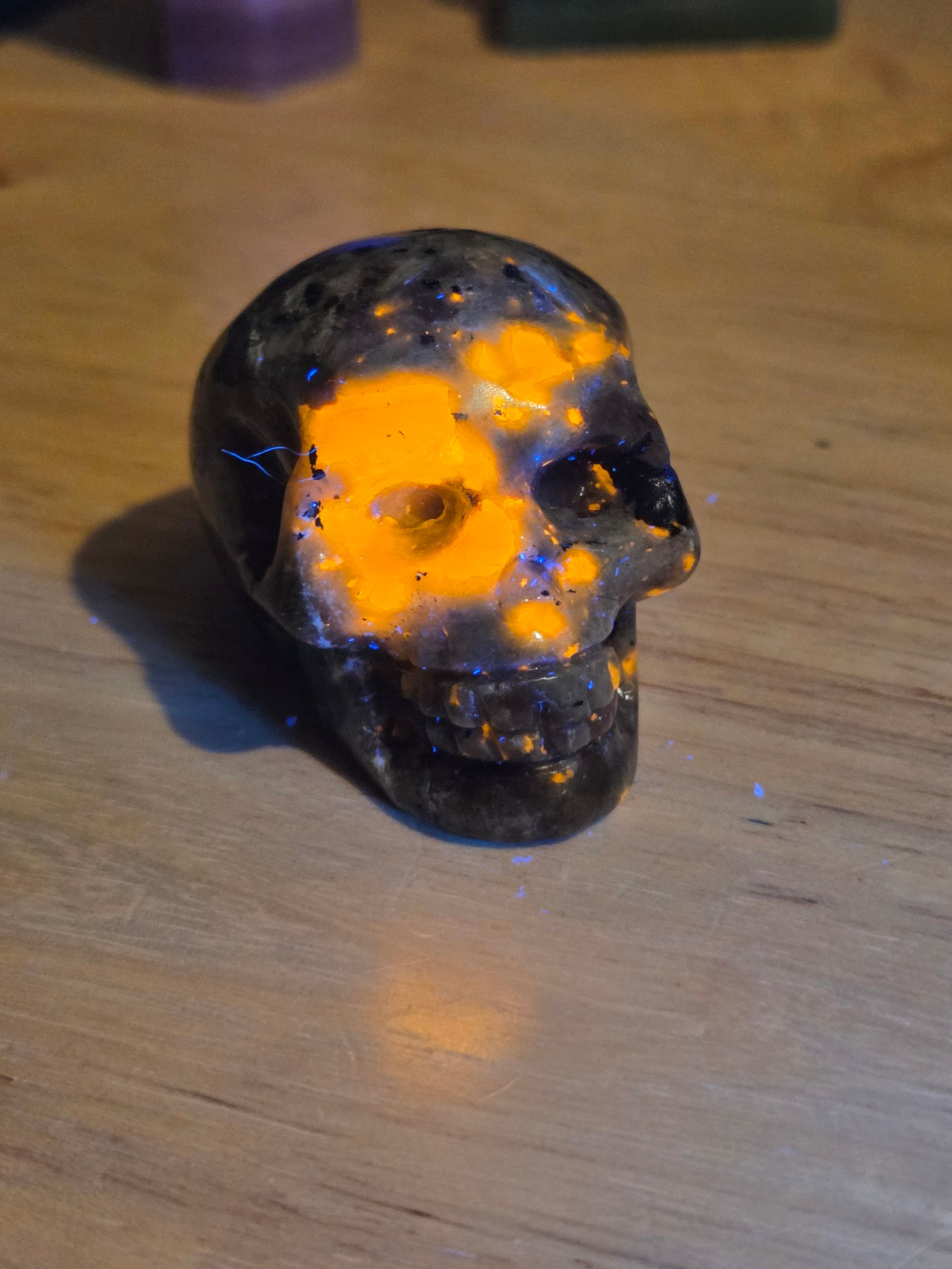 Yooperlite crystal skull carving with orange uv