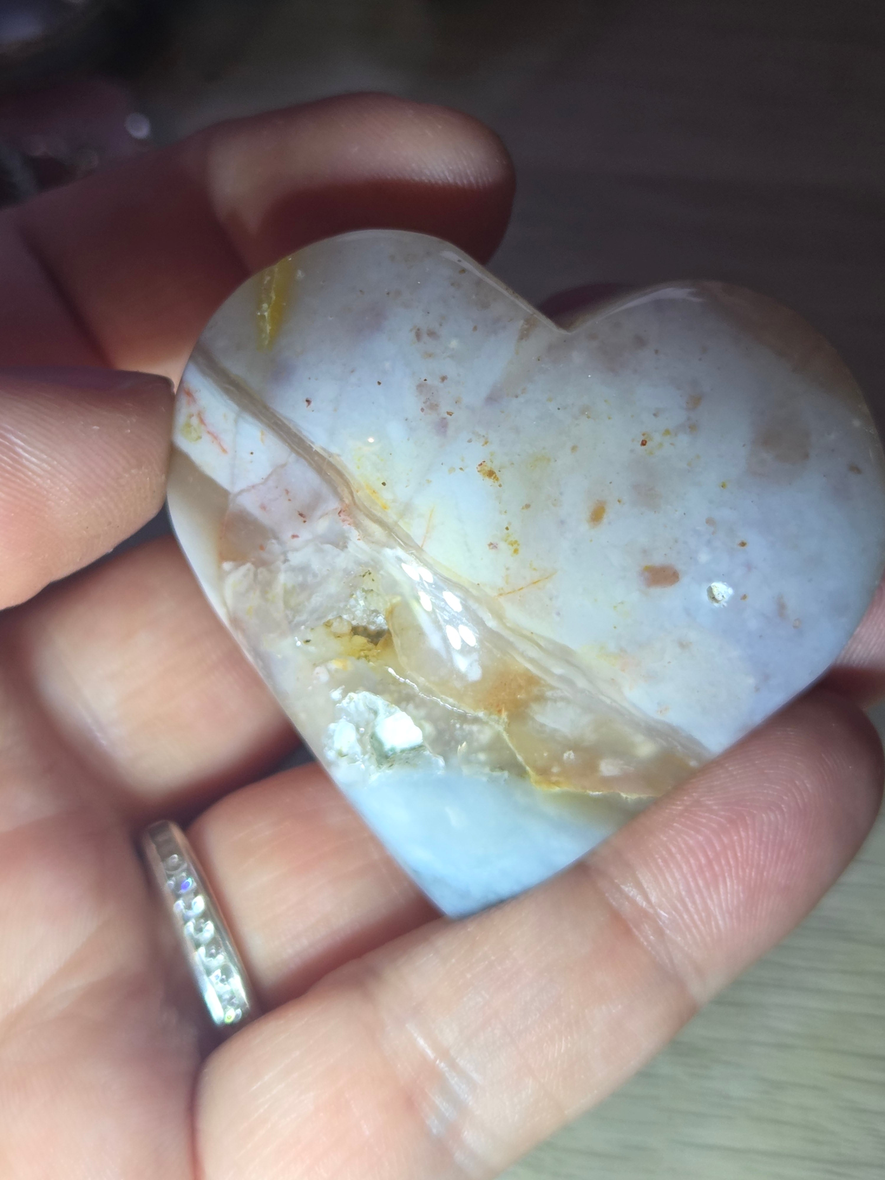 Pink petrified wood heart carving with UV