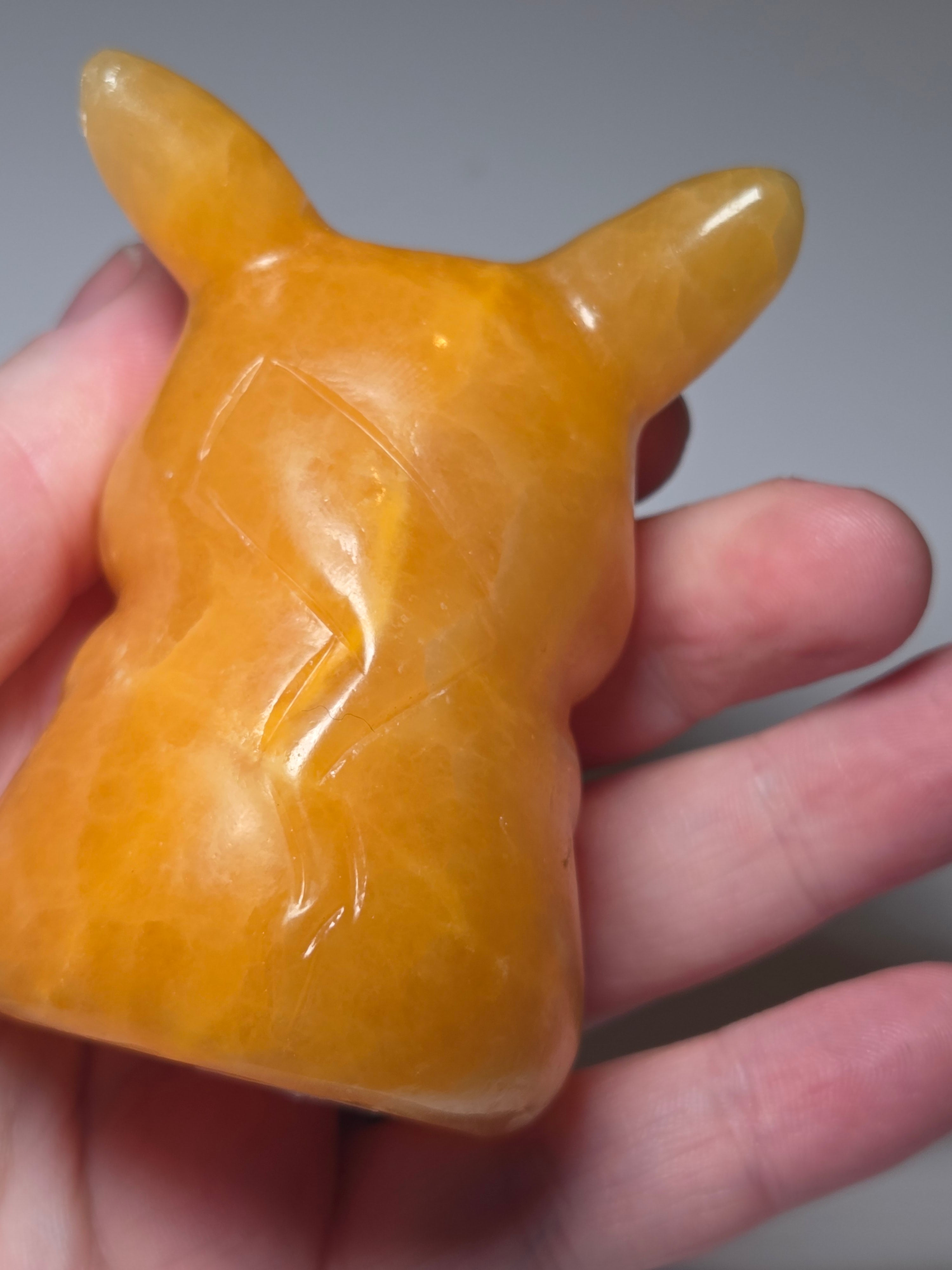 Orange calcite crystal pikachu pokemon carving