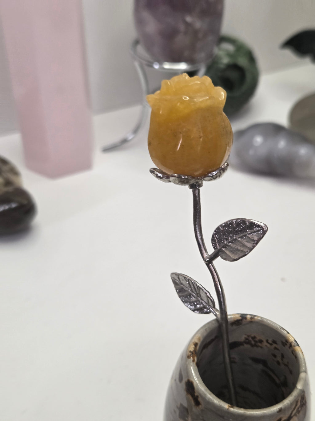 Golden healer crystal rose carving on a stem