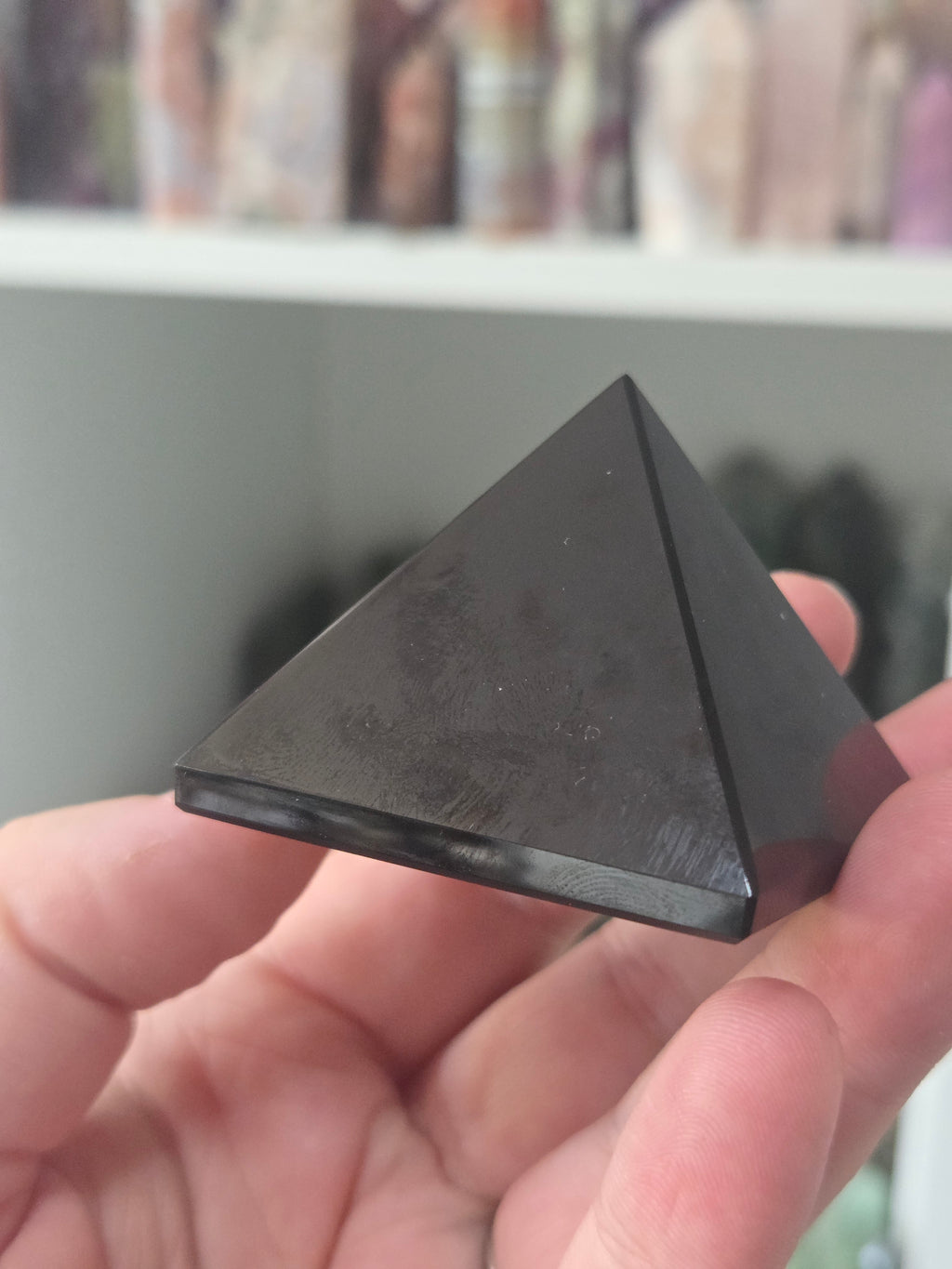 Black obsidian crystal pyramid carving