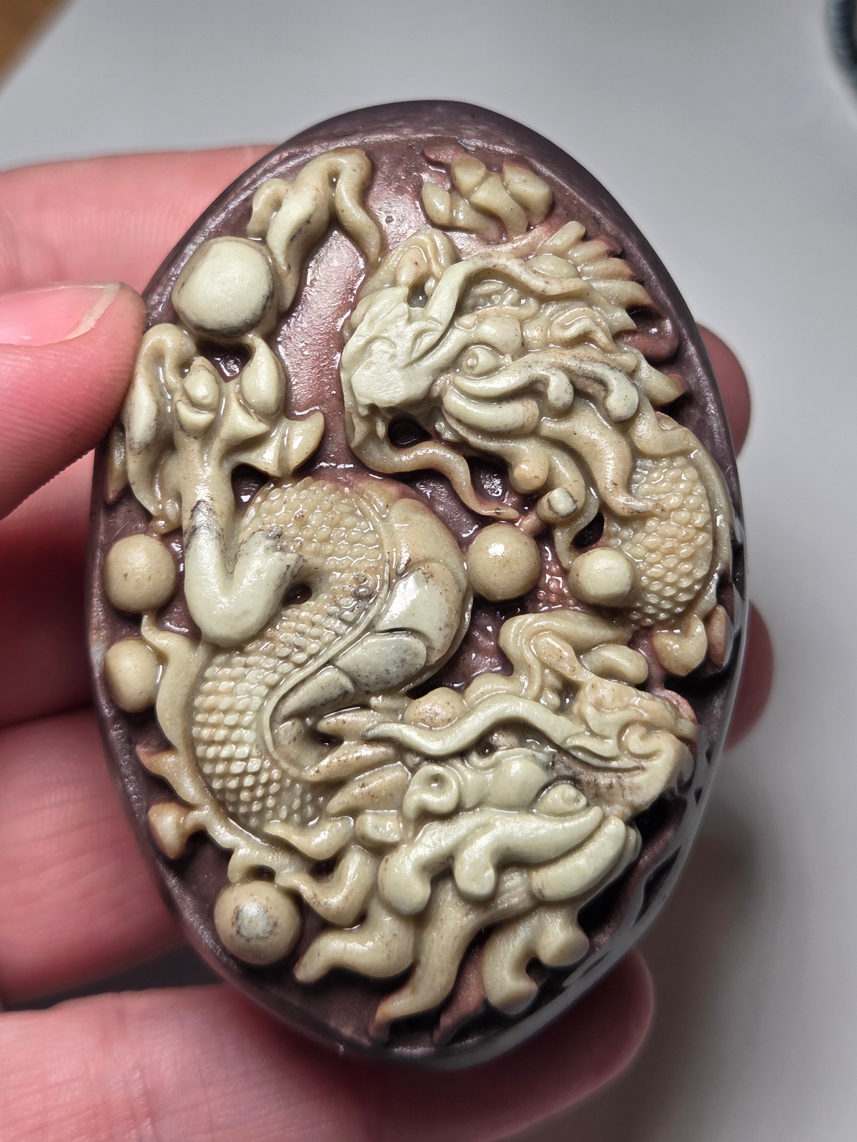 Handmade carved dragon palm stone in purple jade from Province