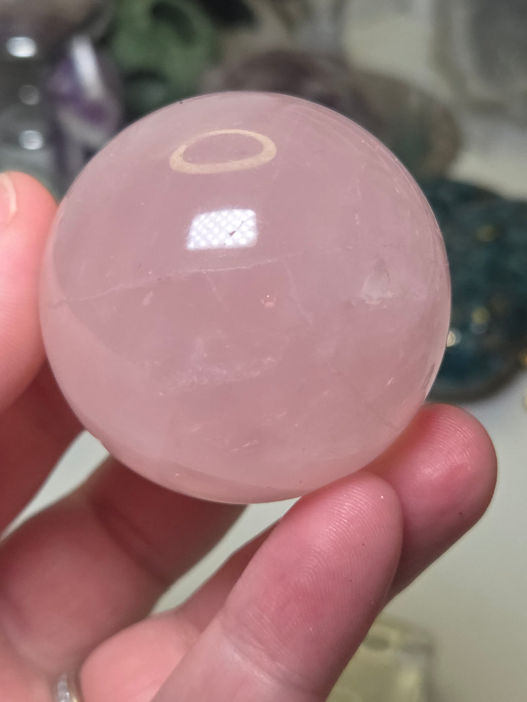 Rose quartz crystal sphere with  crack line and star flash