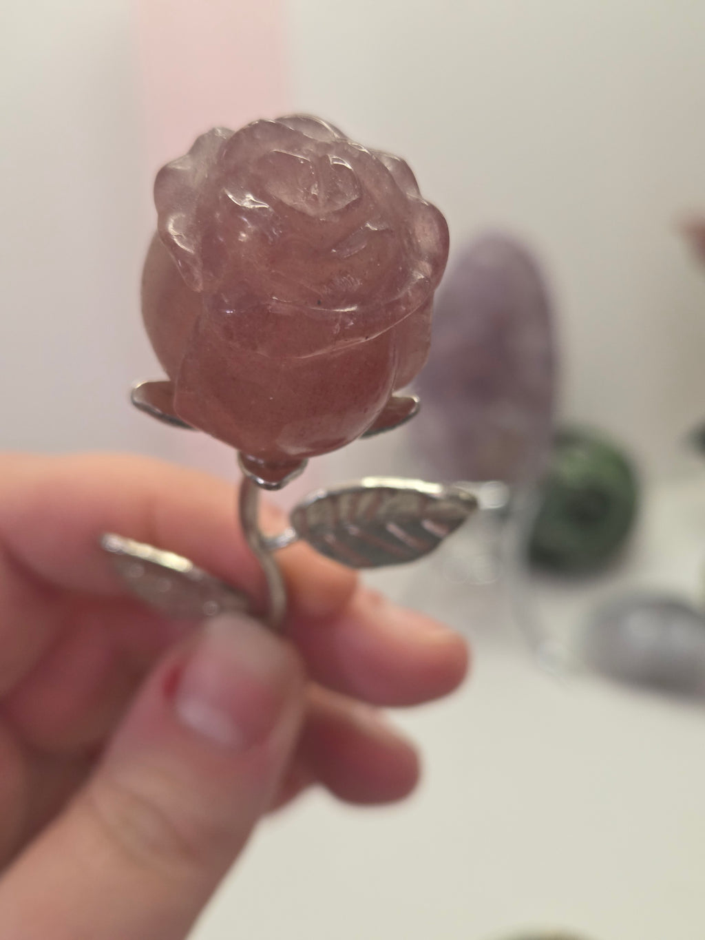 Strawberry quartz crystal rose carving on a stem