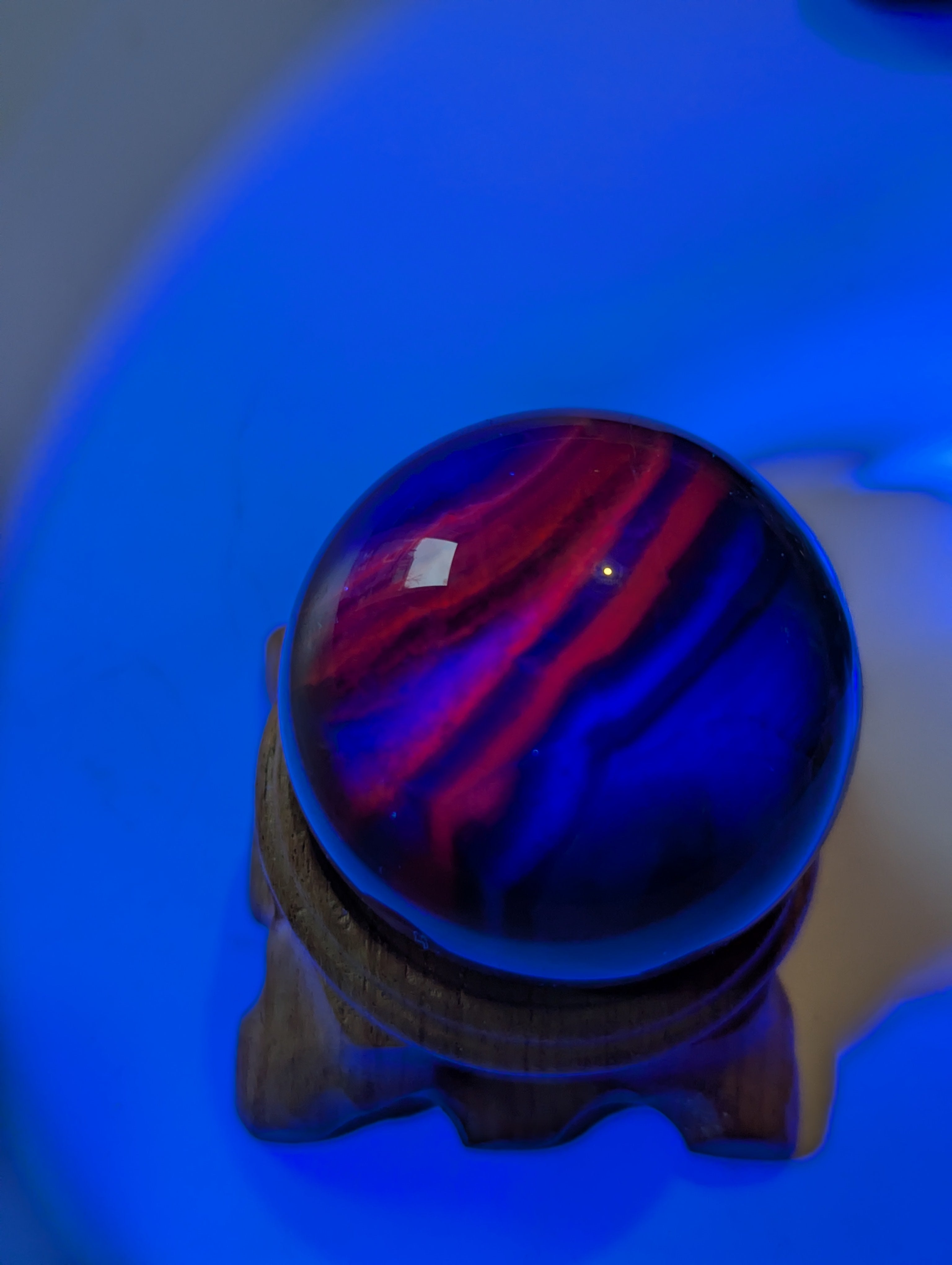 Black flourite crystal sphere with red UV with stand