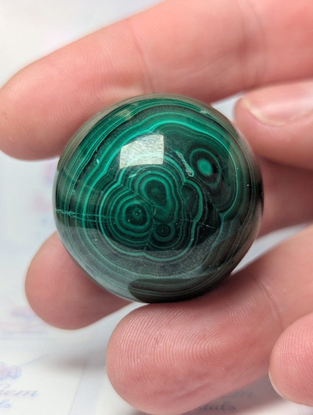 Malicite crystal sphere with imperfections