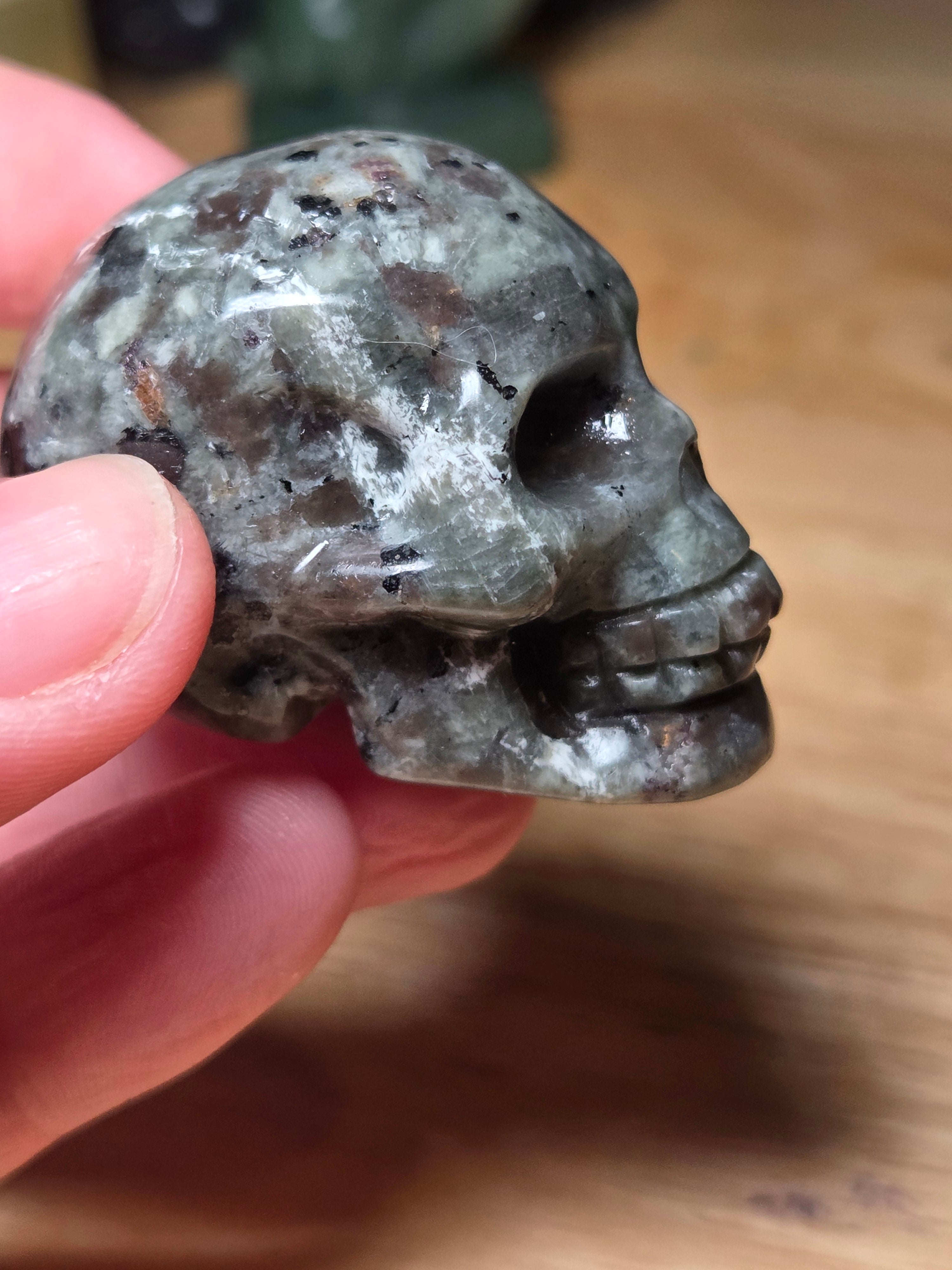 Yooperlite crystal skull carving with orange uv