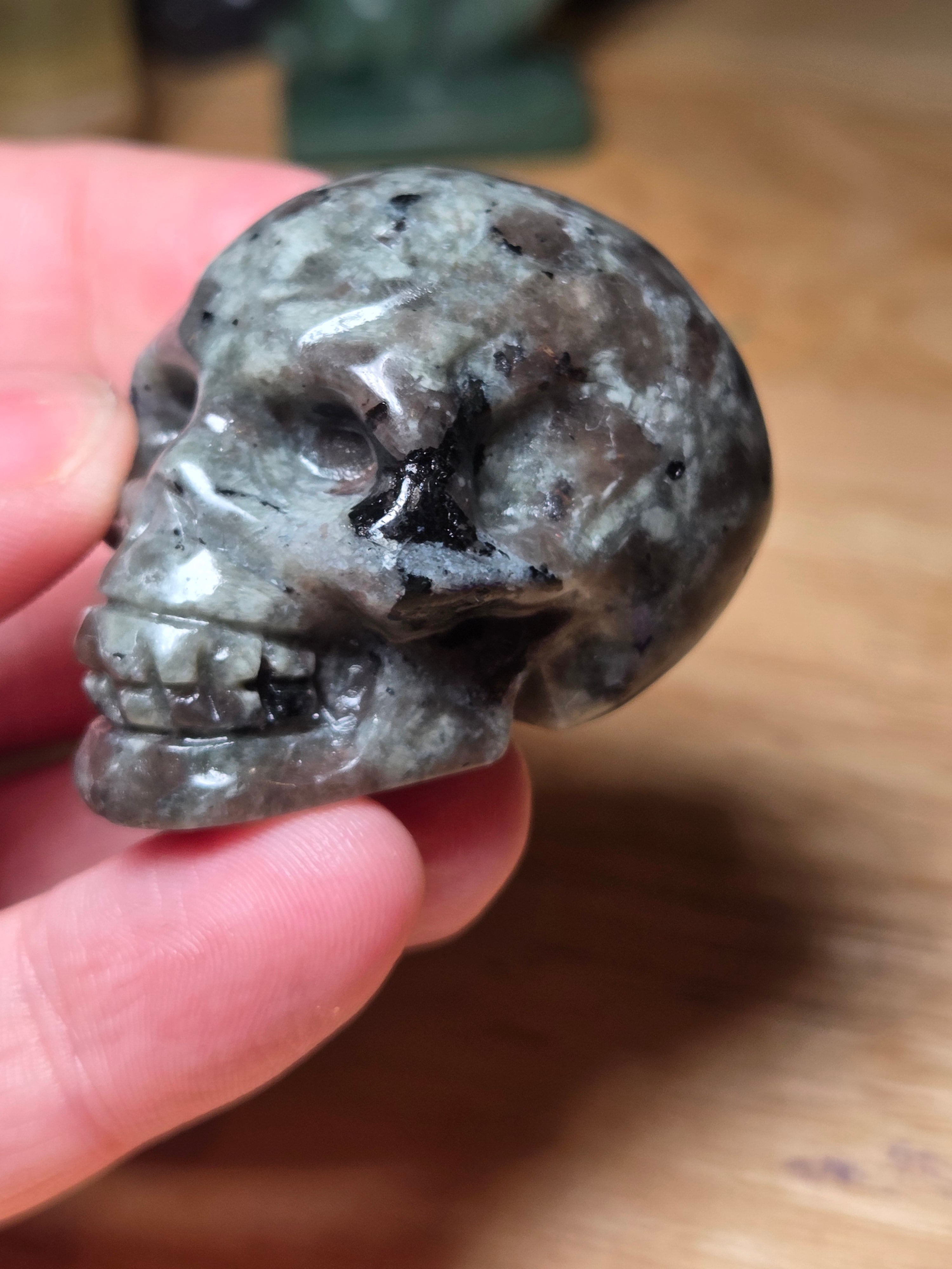 Yooperlite crystal skull carving with orange uv