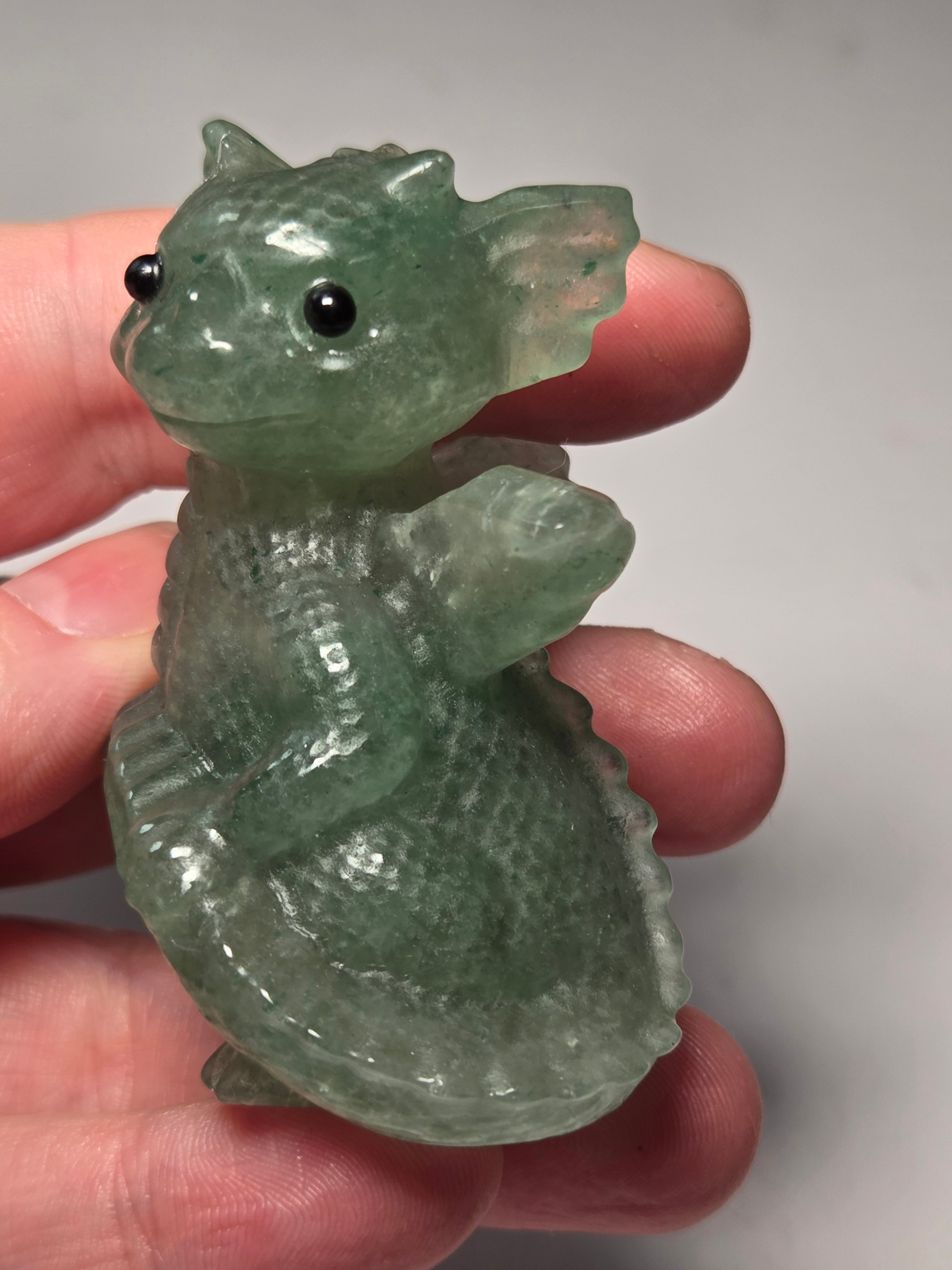 Baby dragon holding tail