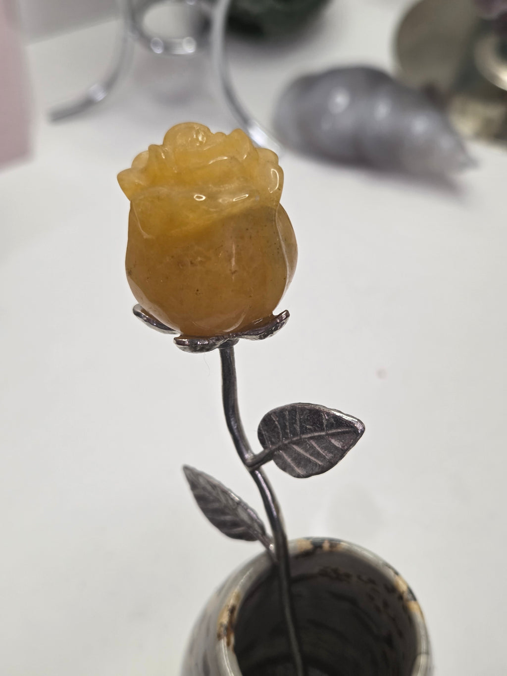 Golden healer crystal rose carving on a stem