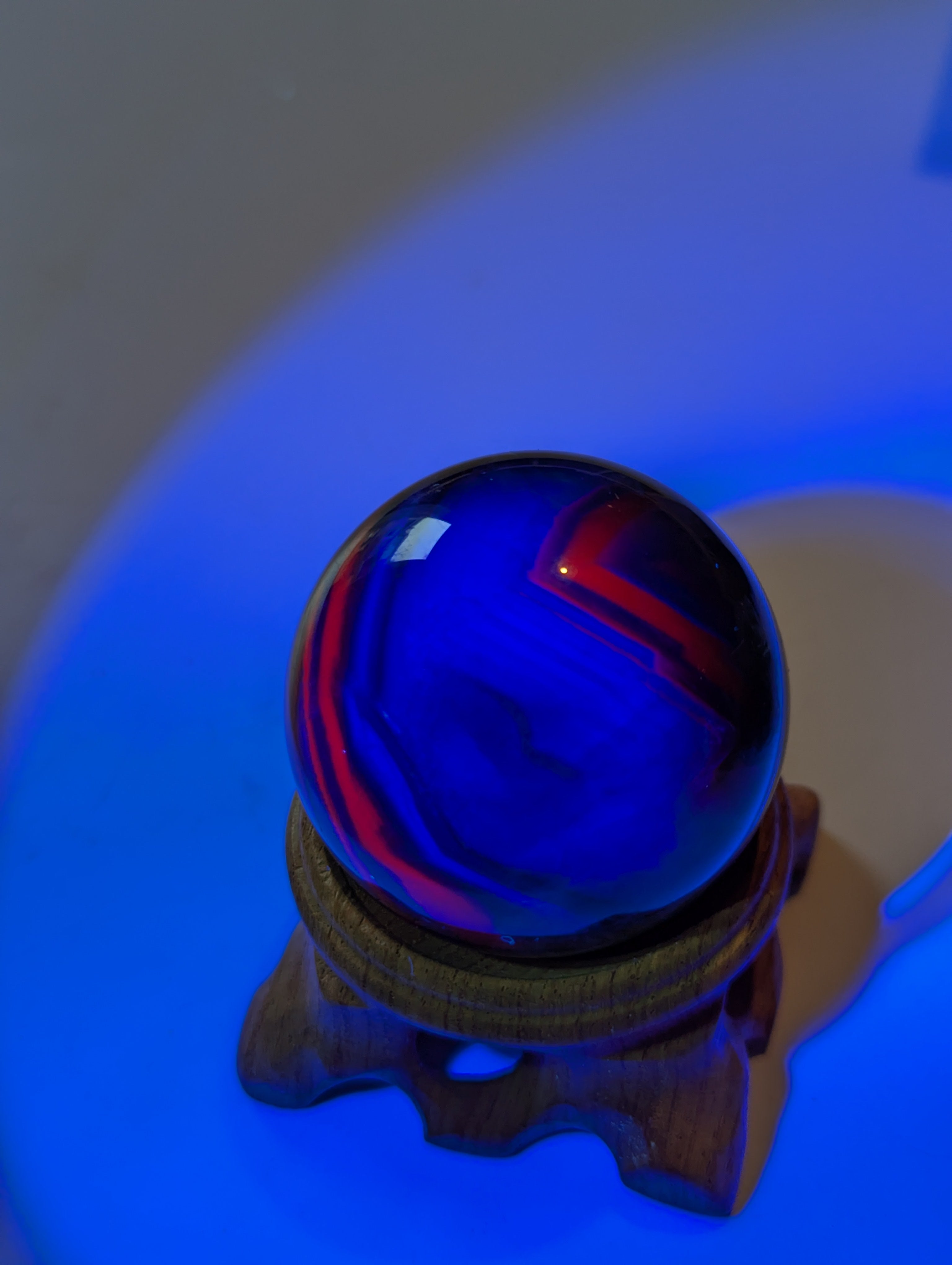 Black flourite crystal sphere with red UV with stand