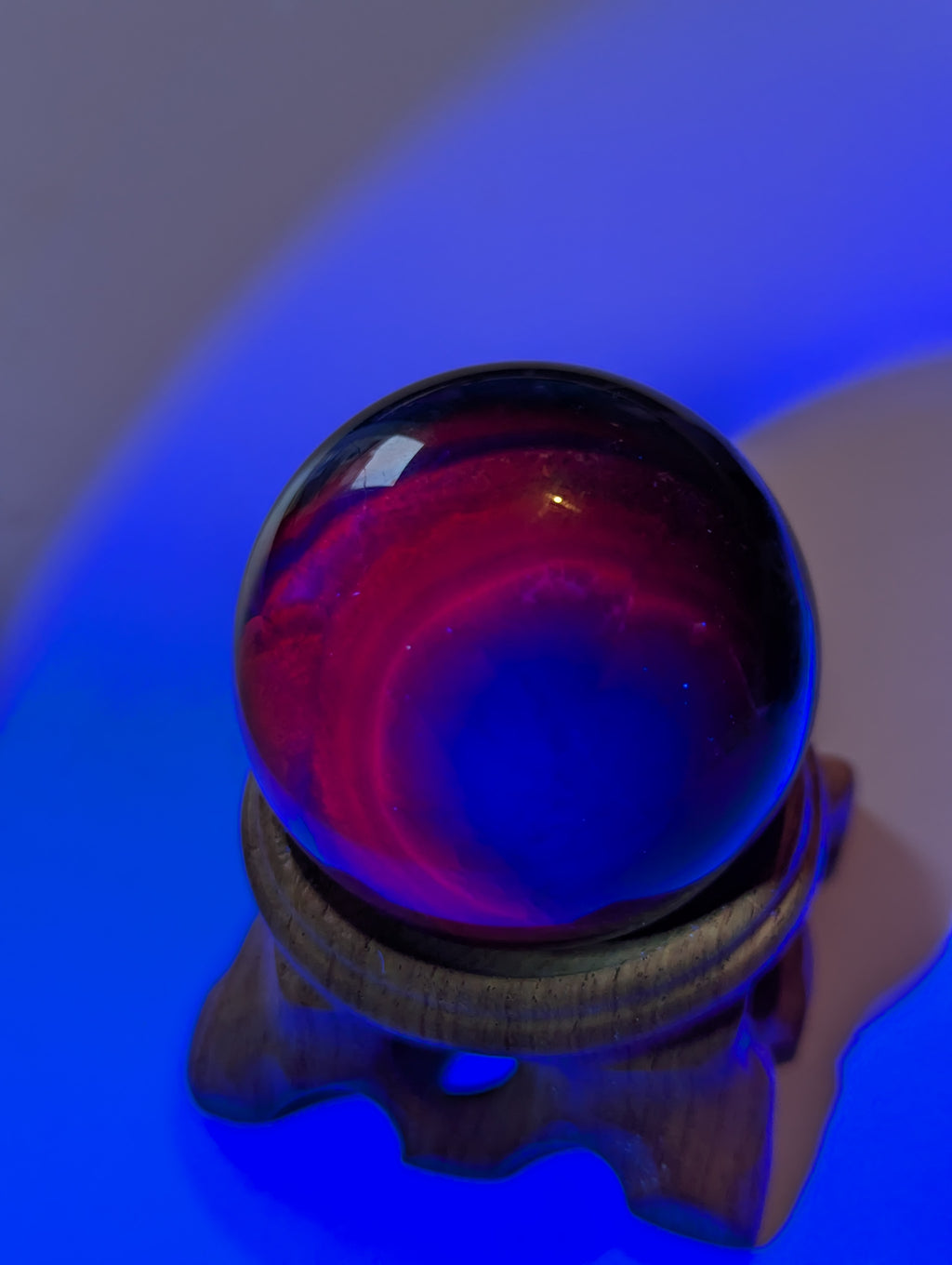 Black flourite crystal sphere with red UV with stand