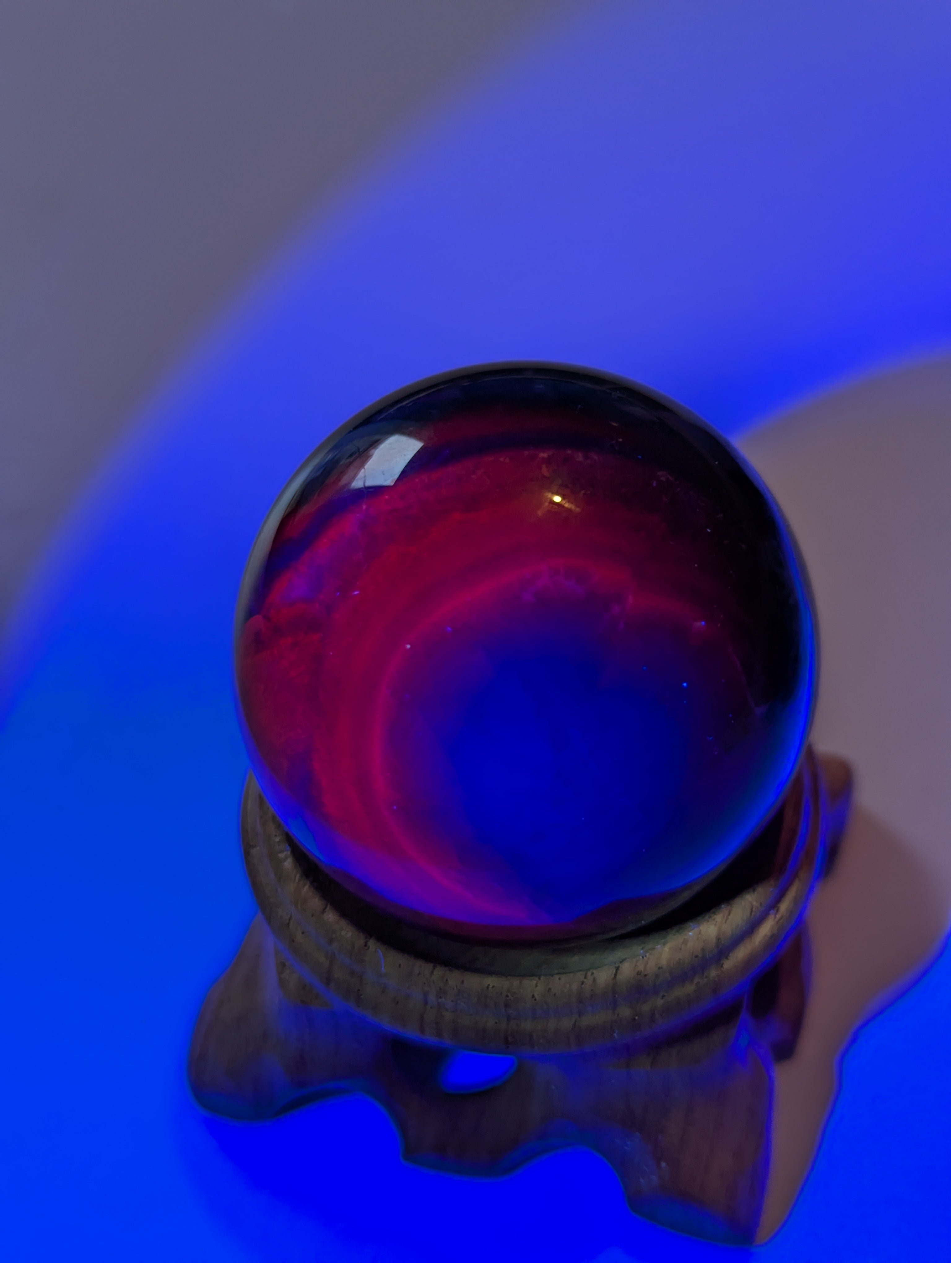 Black flourite crystal sphere with red UV with stand