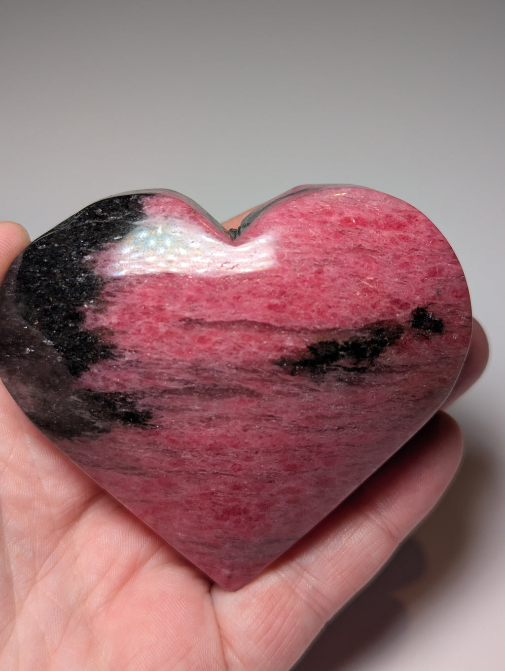 Large Rhodonite crystal heart carving with stand