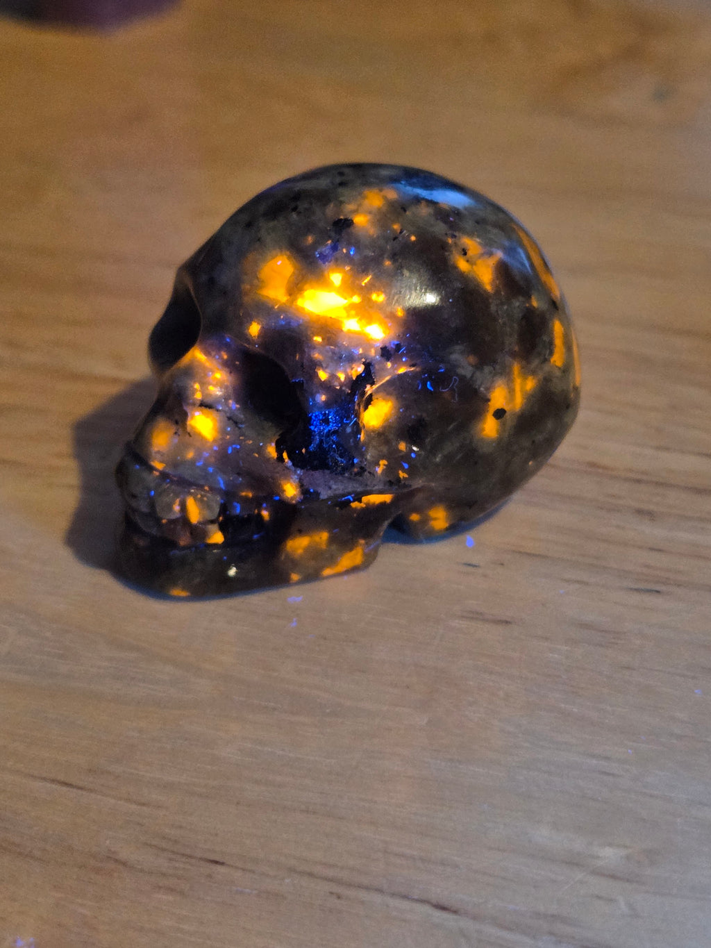 Yooperlite crystal skull carving with orange uv