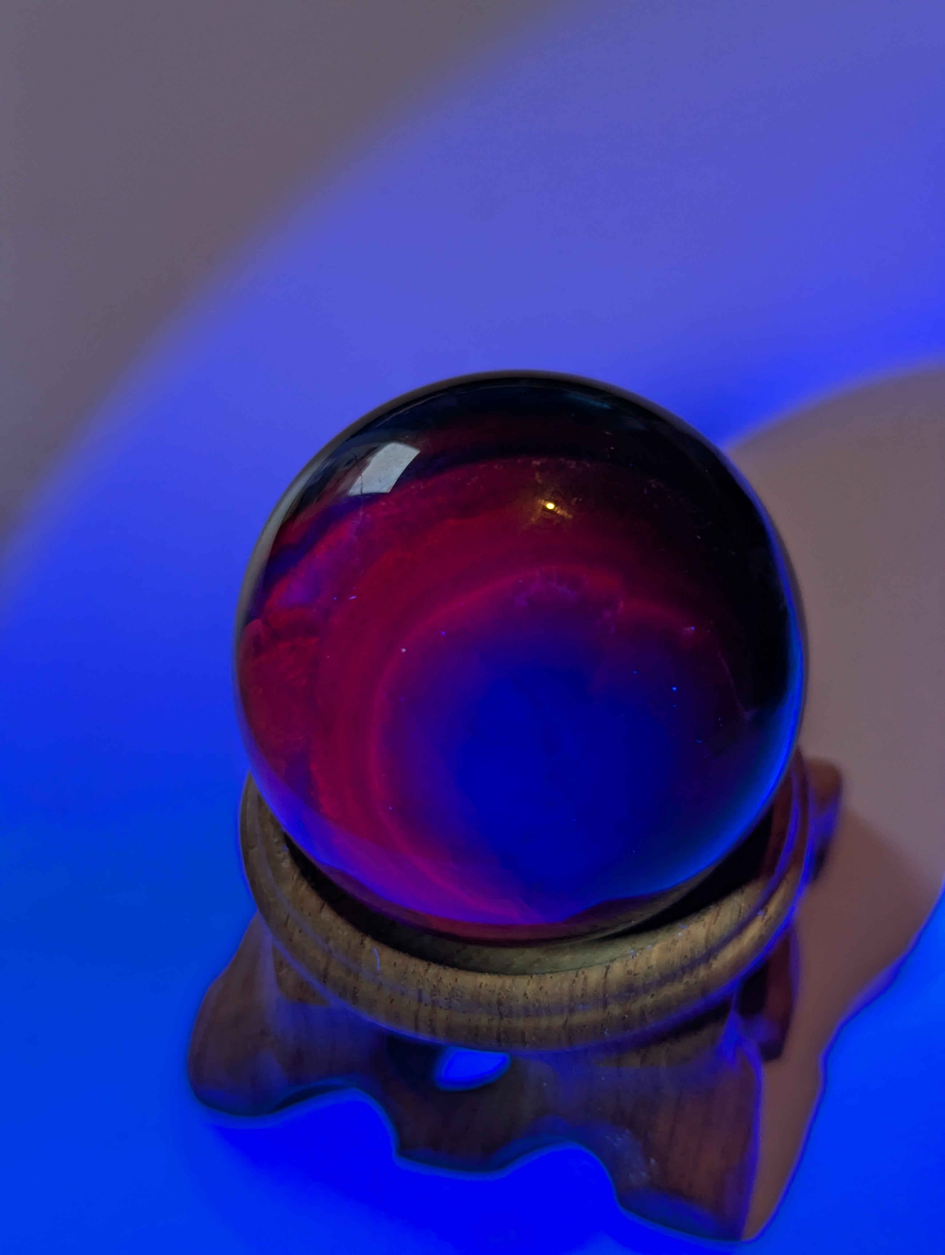 Black flourite crystal sphere with red UV with stand