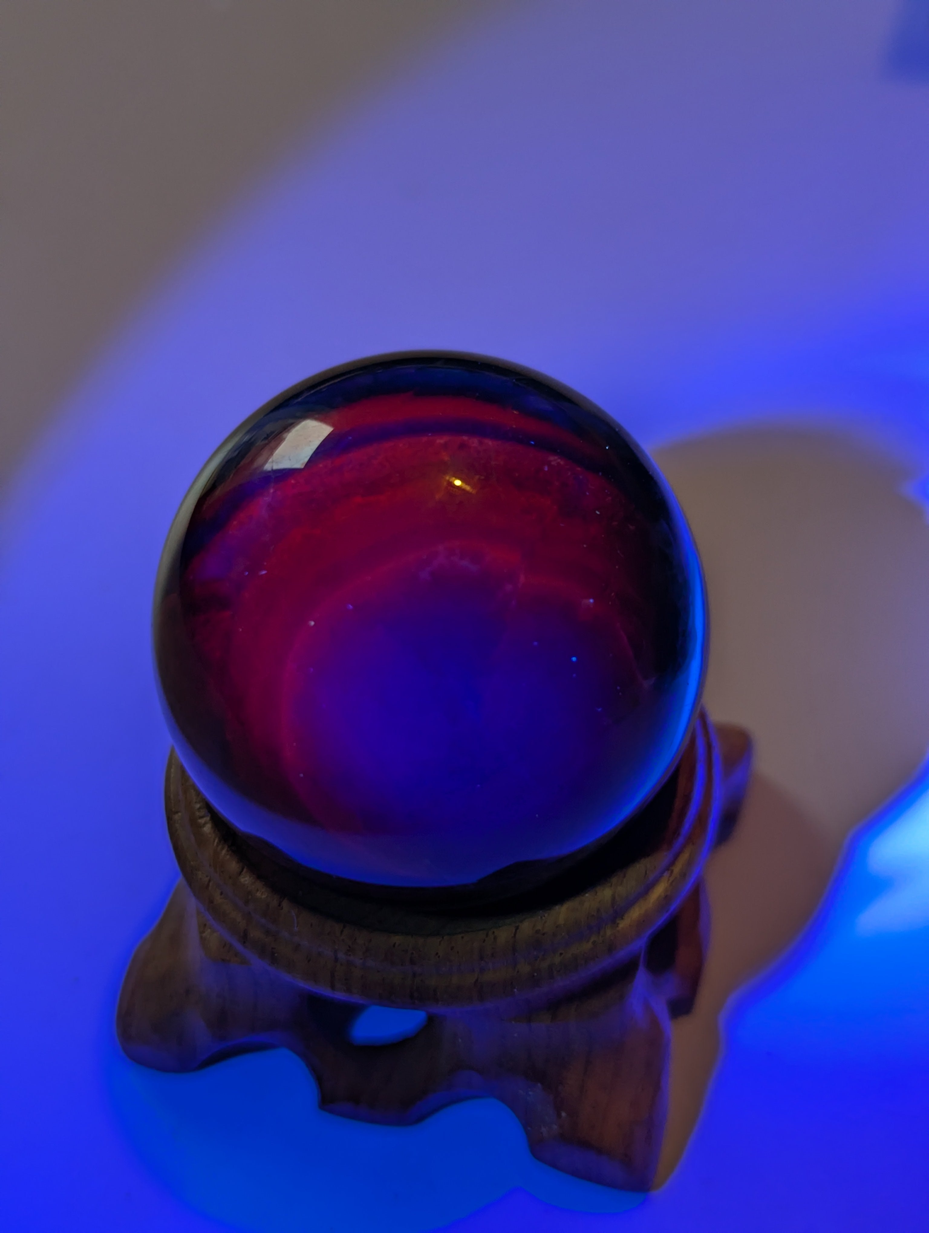 Black flourite crystal sphere with red UV with stand