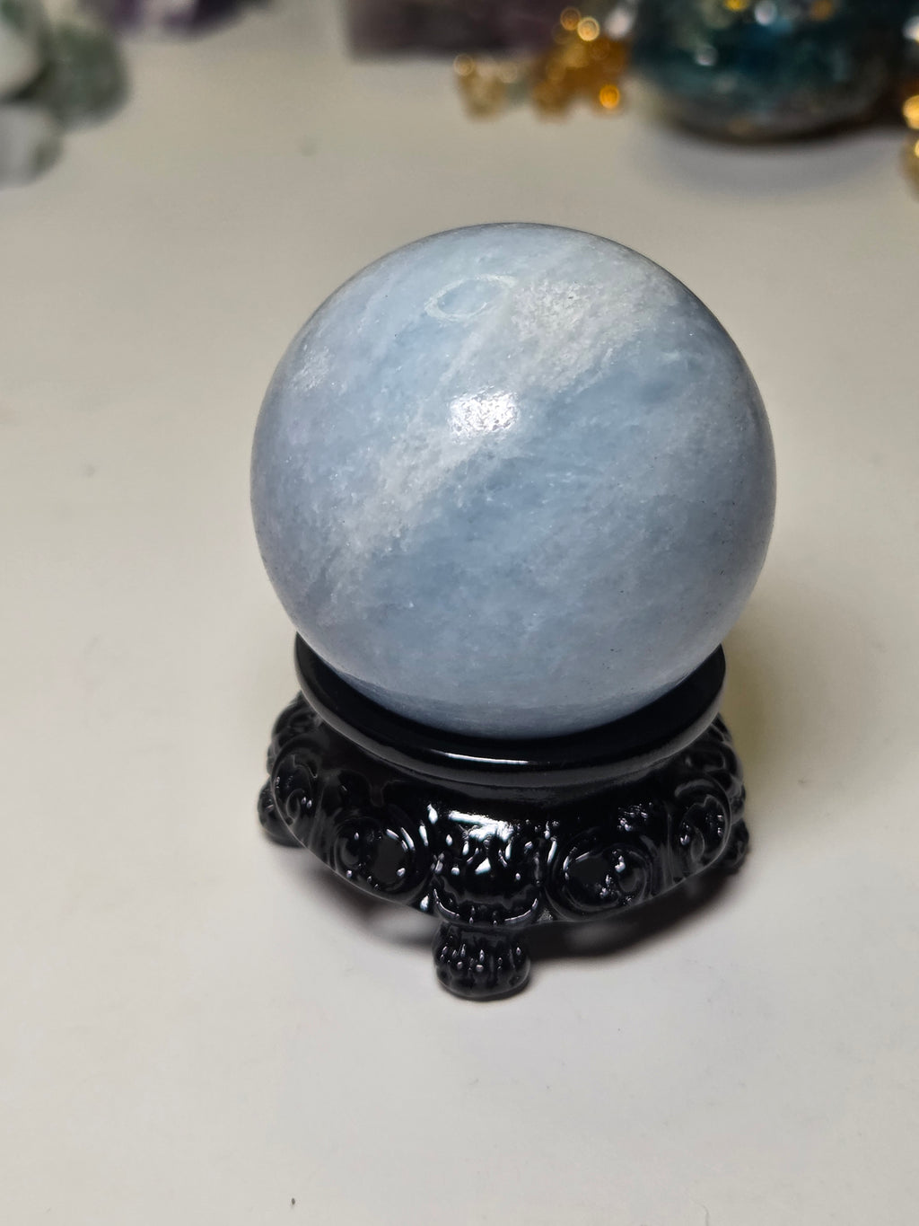 Blue calcite crystal sphere with stand