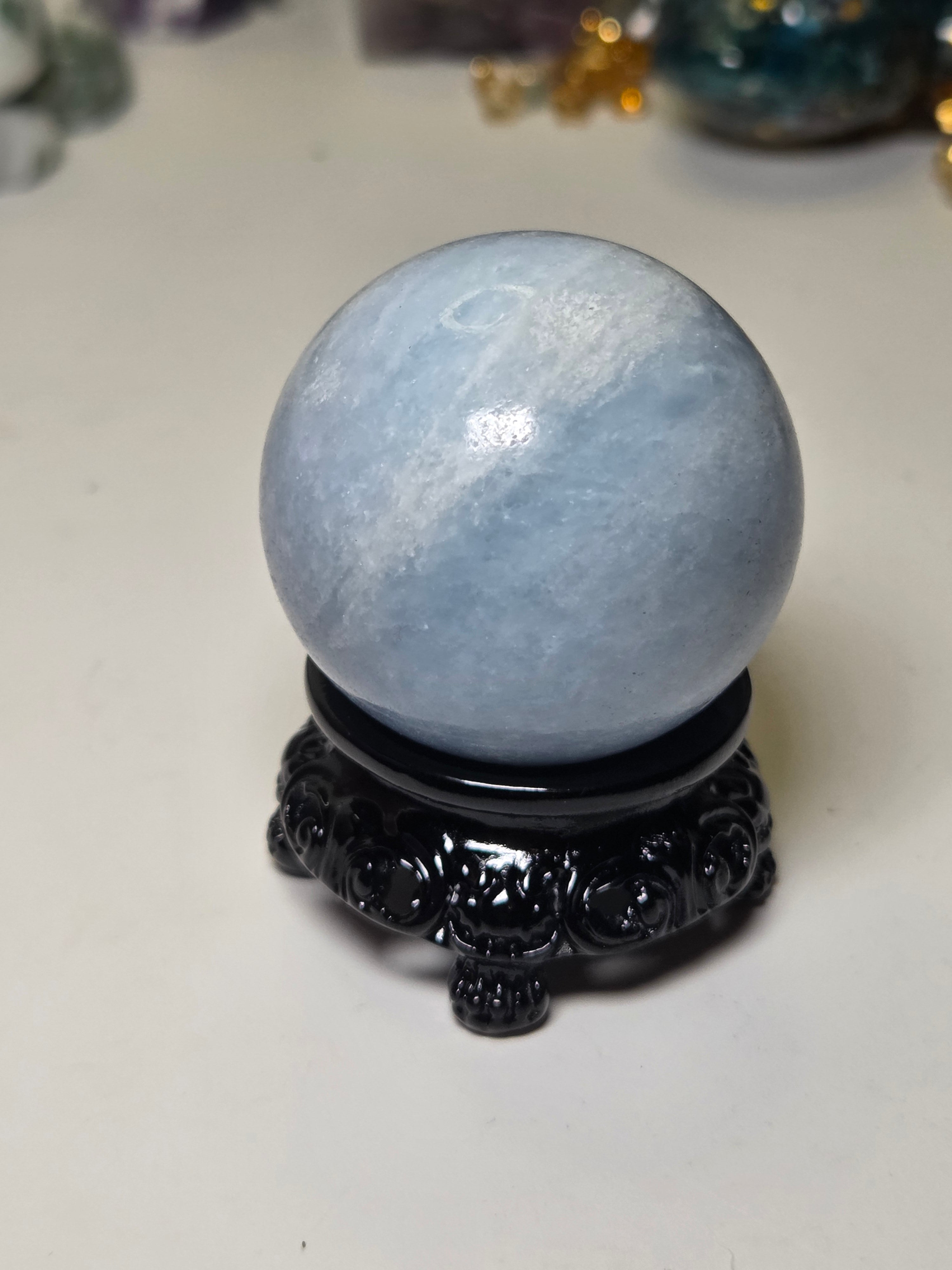 Blue calcite crystal sphere with stand