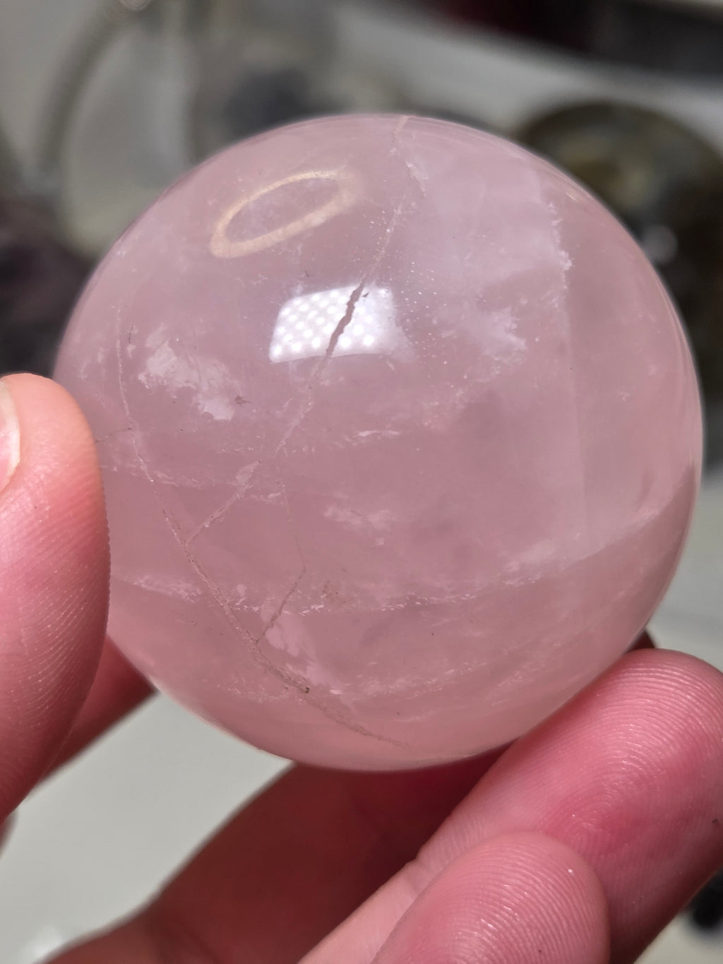 Rose quartz crystal sphere with  crack line and star flash
