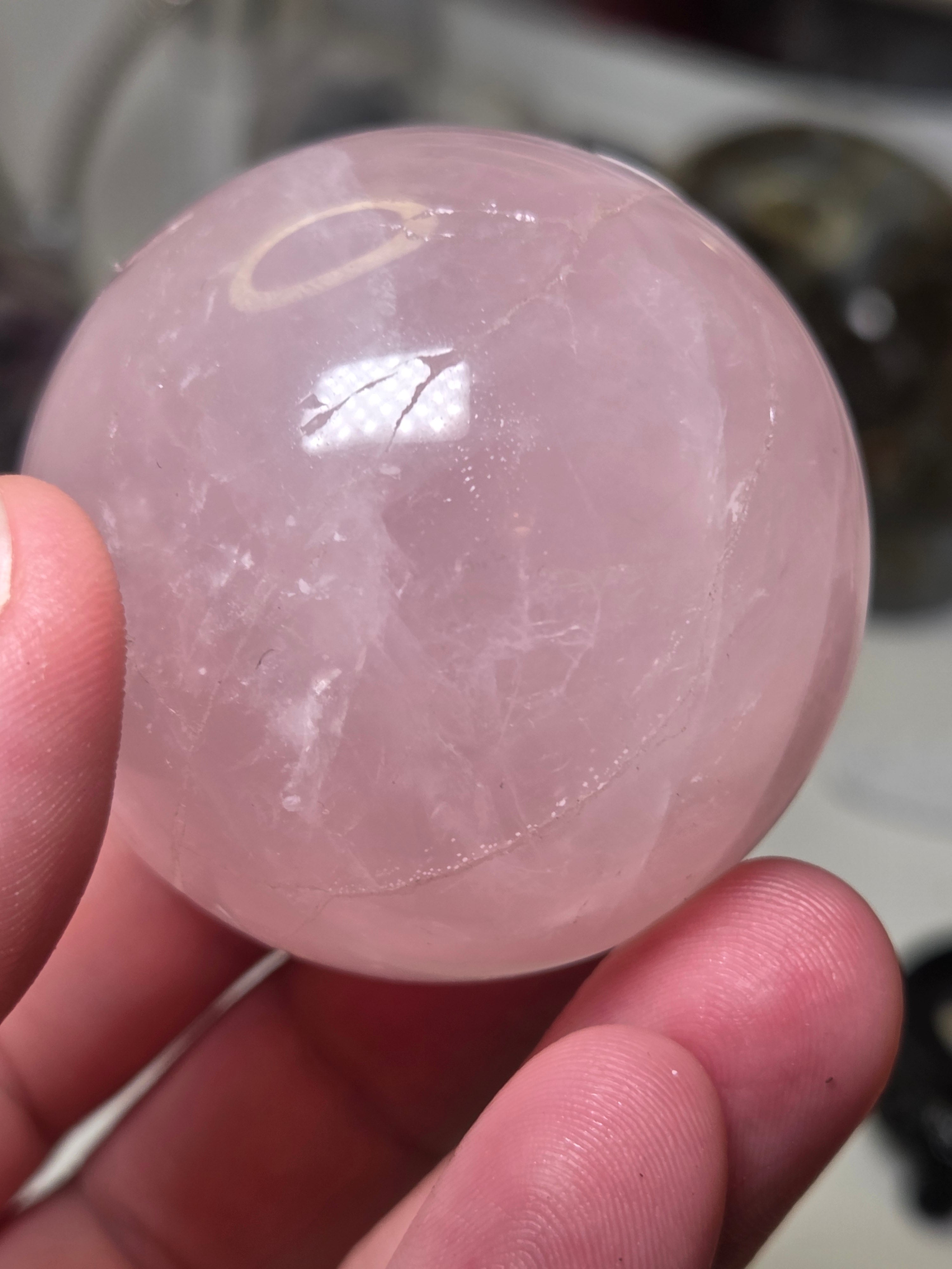 Rose quartz crystal sphere with  crack line and star flash