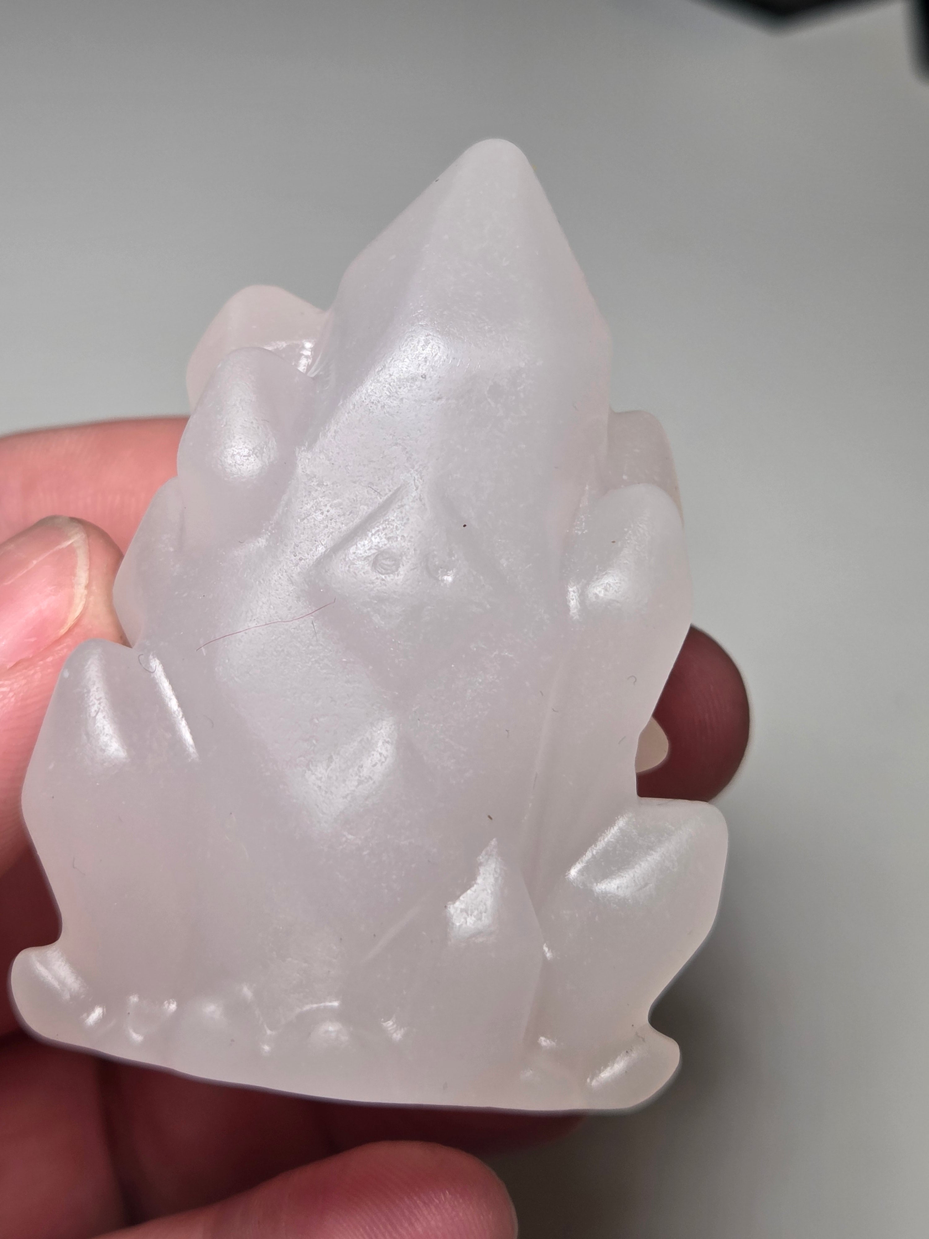 Pink calcite crystal cluster  house carving