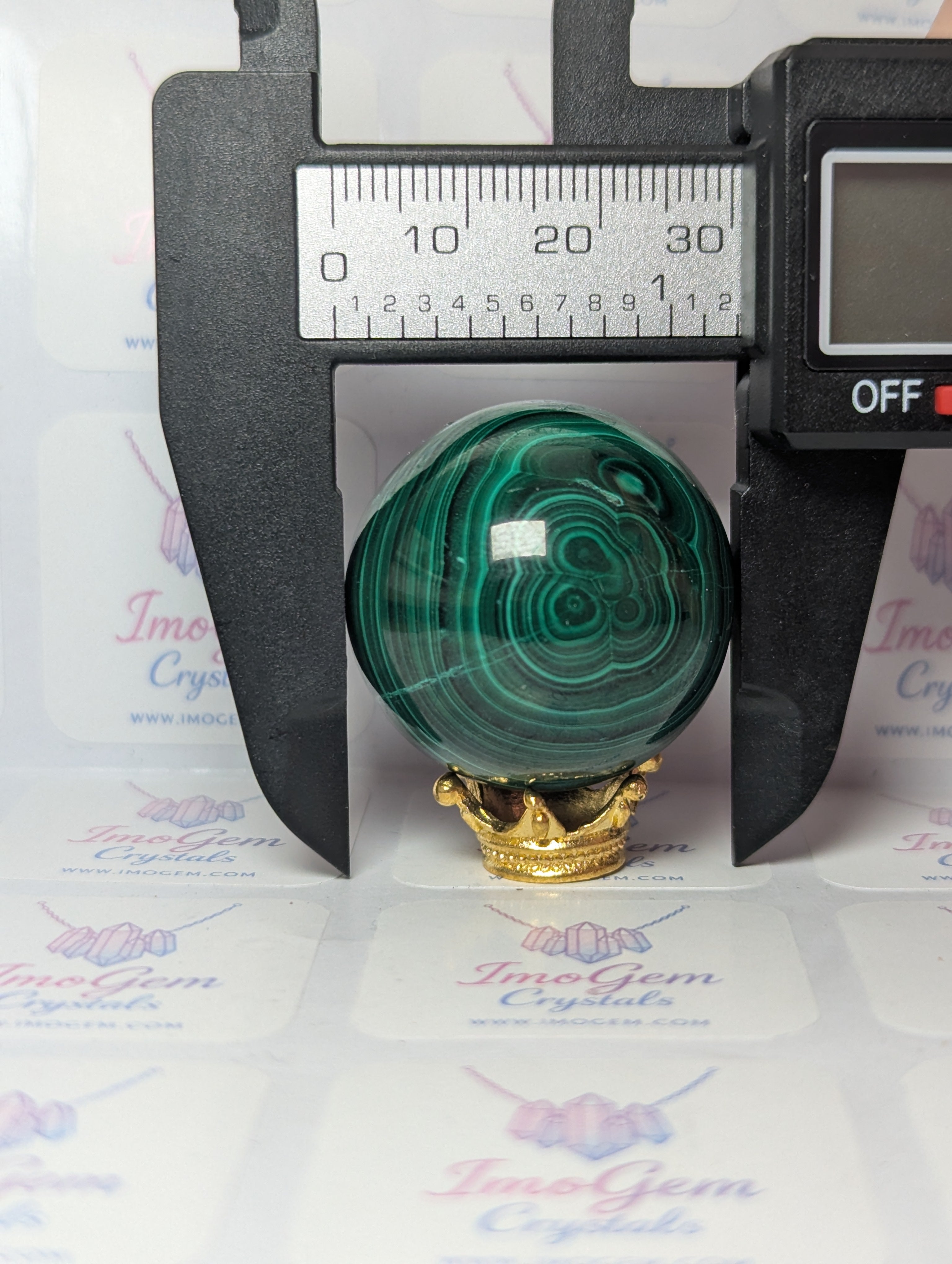 Malicite crystal sphere with imperfections