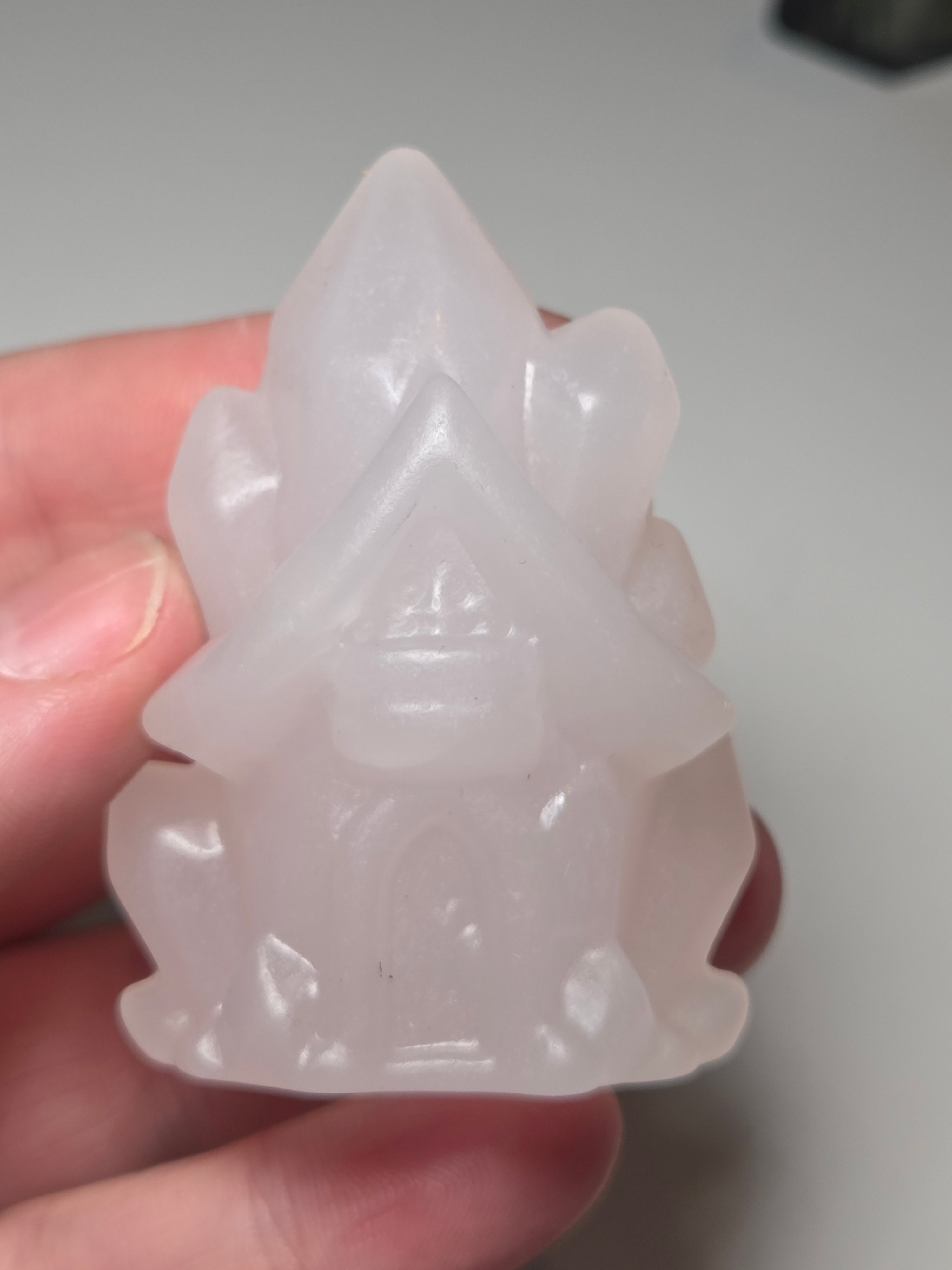 Pink calcite crystal cluster  house carving