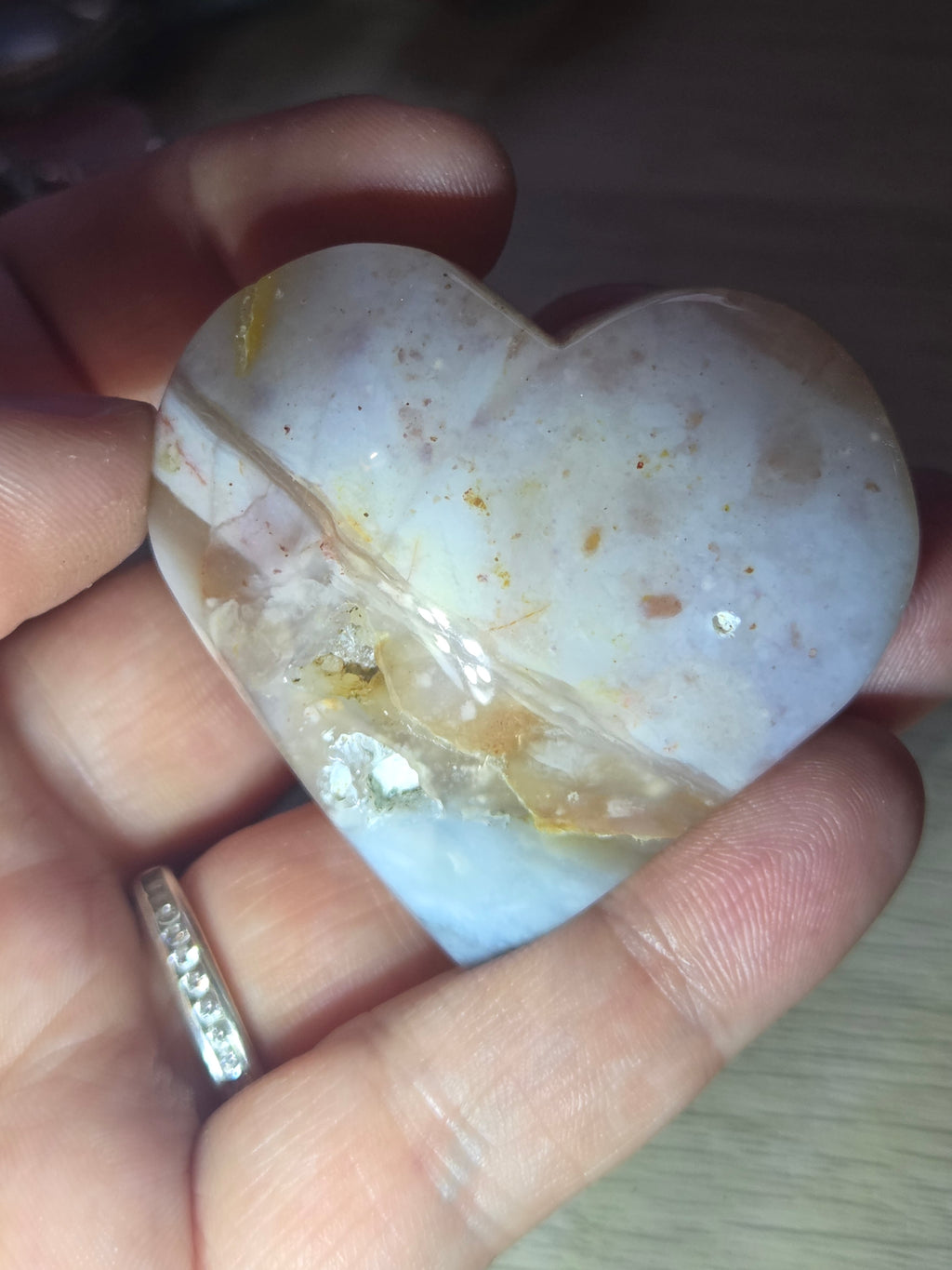Pink petrified wood heart carving with UV