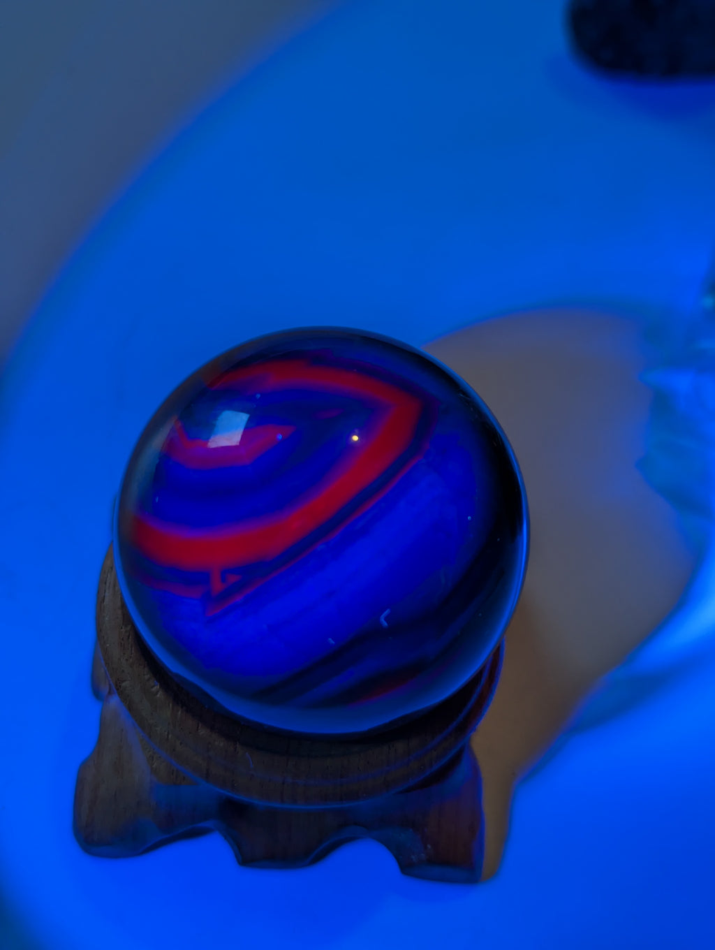 Black flourite crystal sphere with red UV with stand