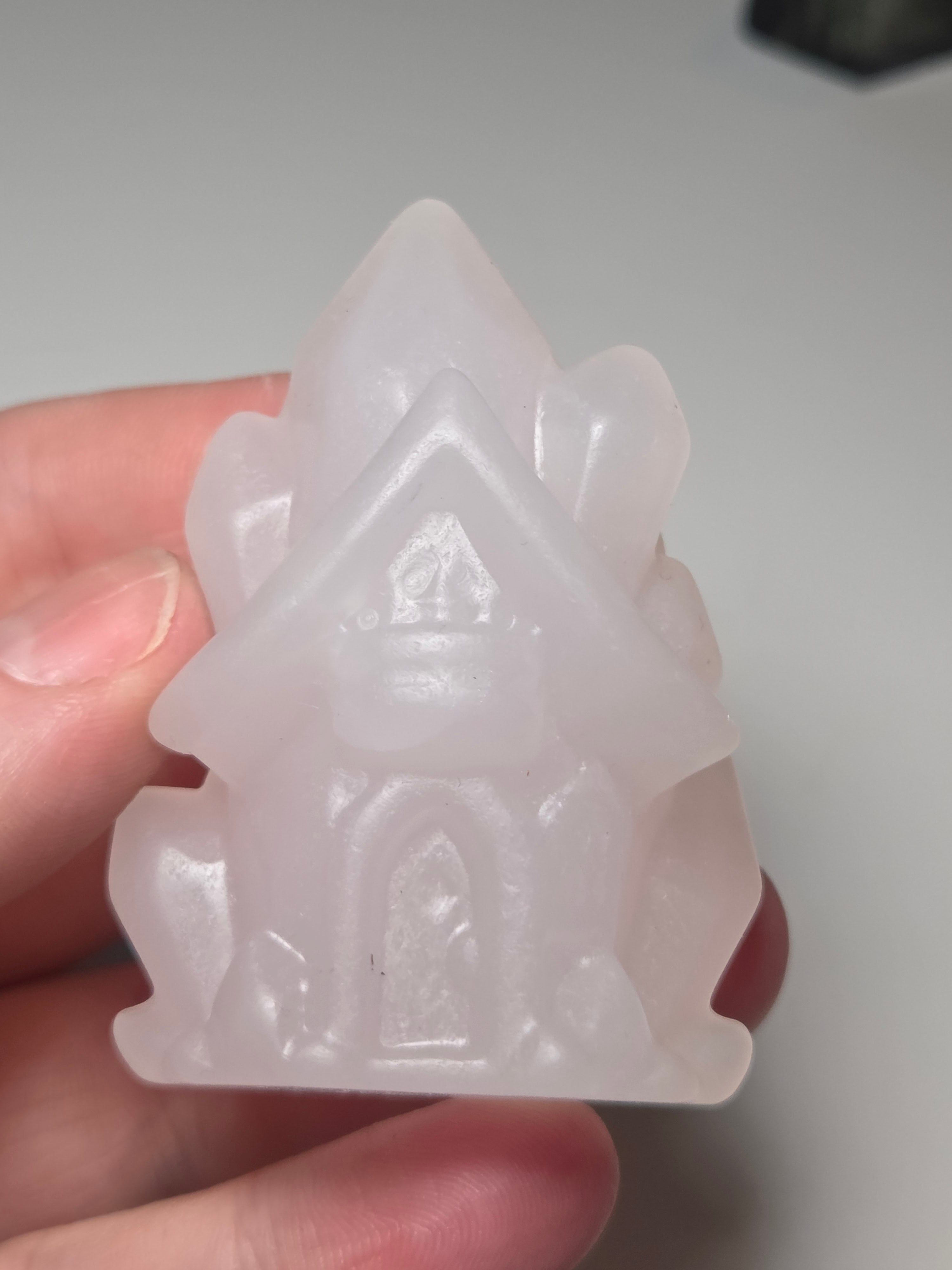 Pink calcite crystal cluster  house carving