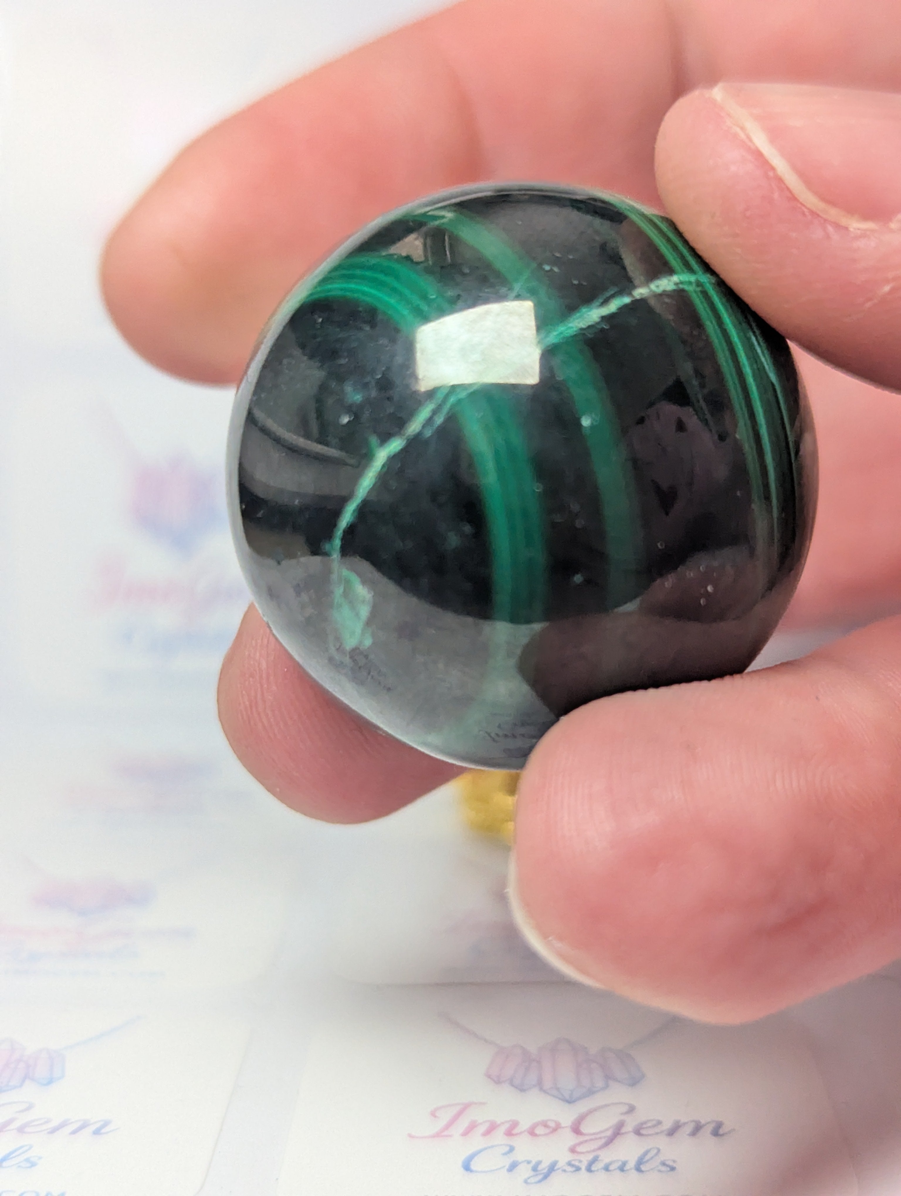Malicite crystal sphere with imperfections