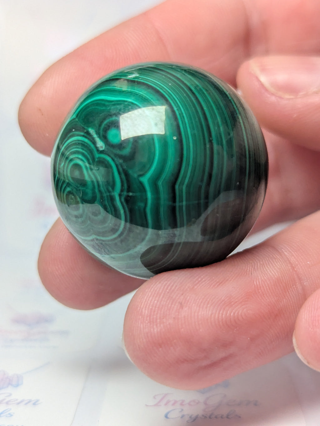 Malicite crystal sphere with imperfections