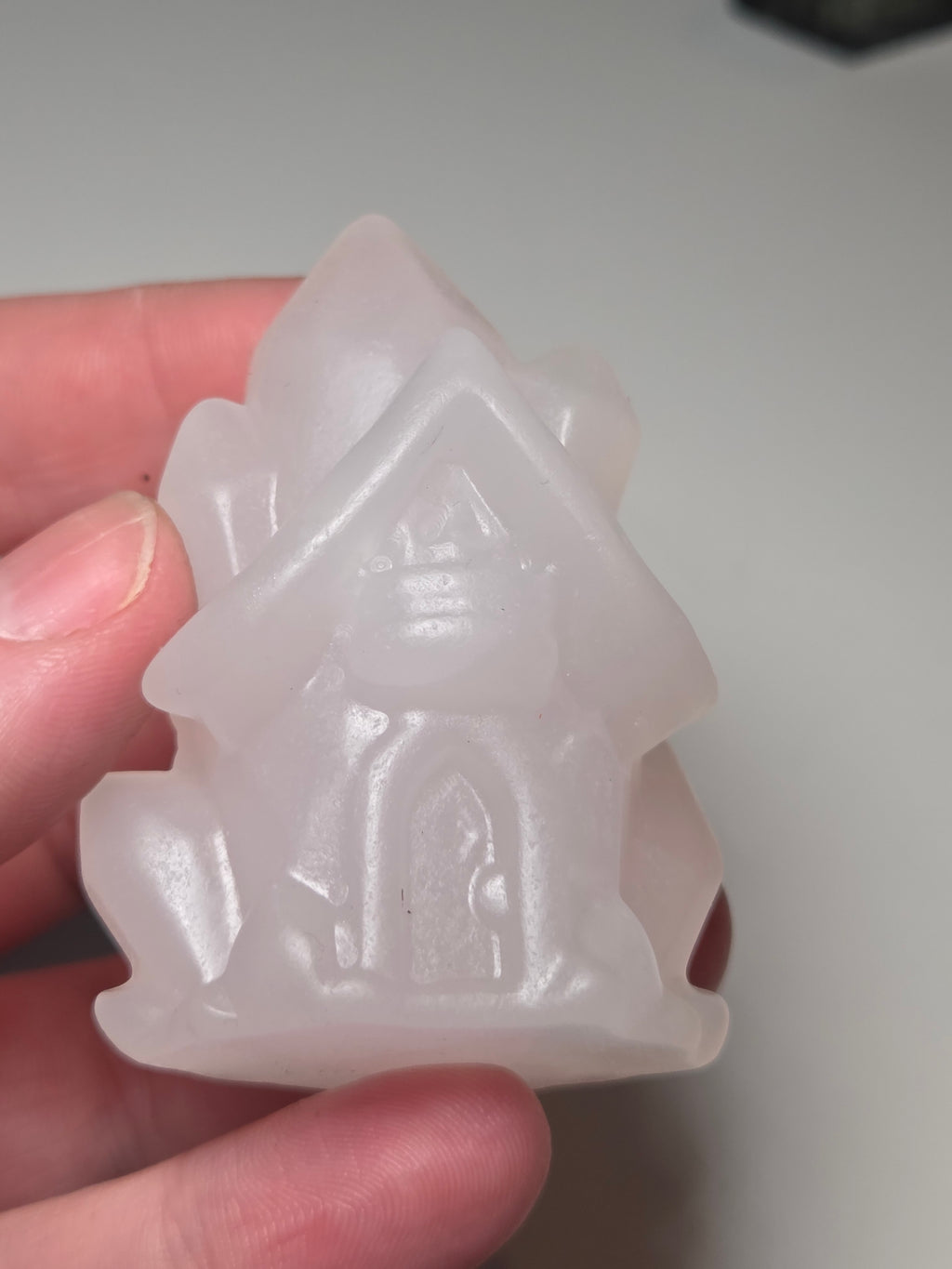 Pink calcite crystal cluster  house carving