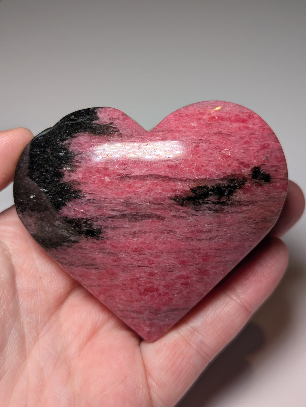 Large Rhodonite crystal heart carving with stand