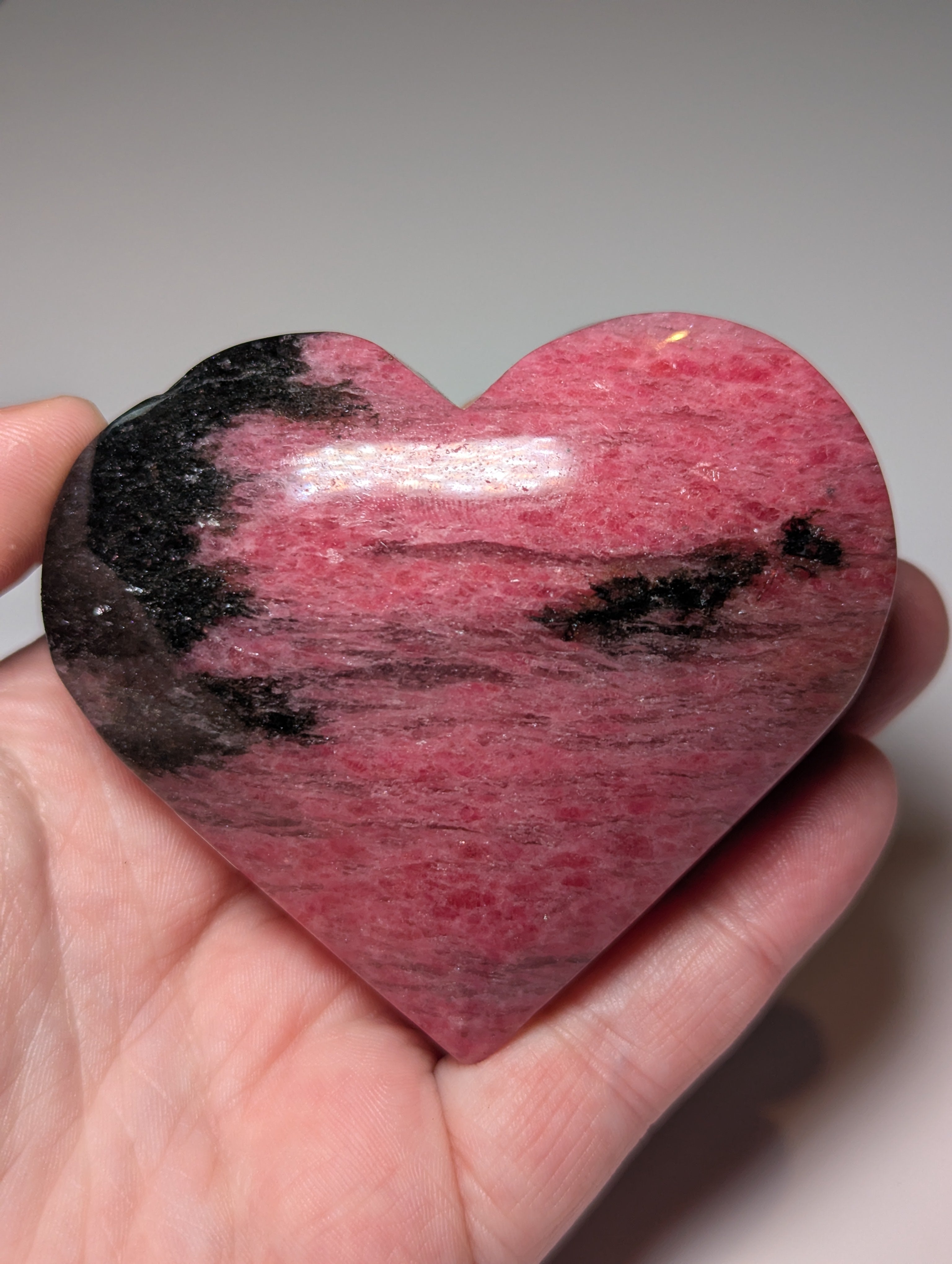 Large Rhodonite crystal heart carving with stand