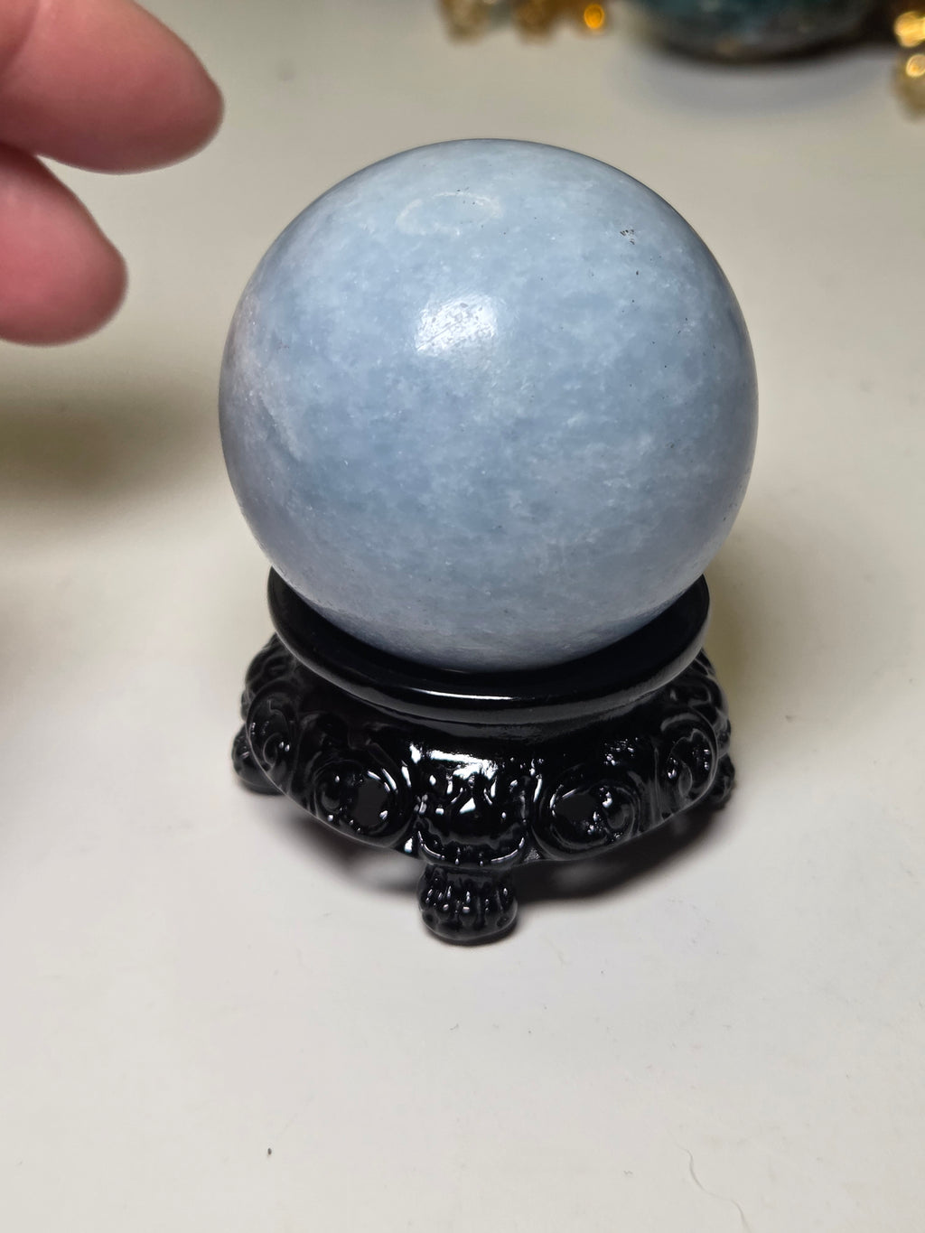 Blue calcite crystal sphere with stand