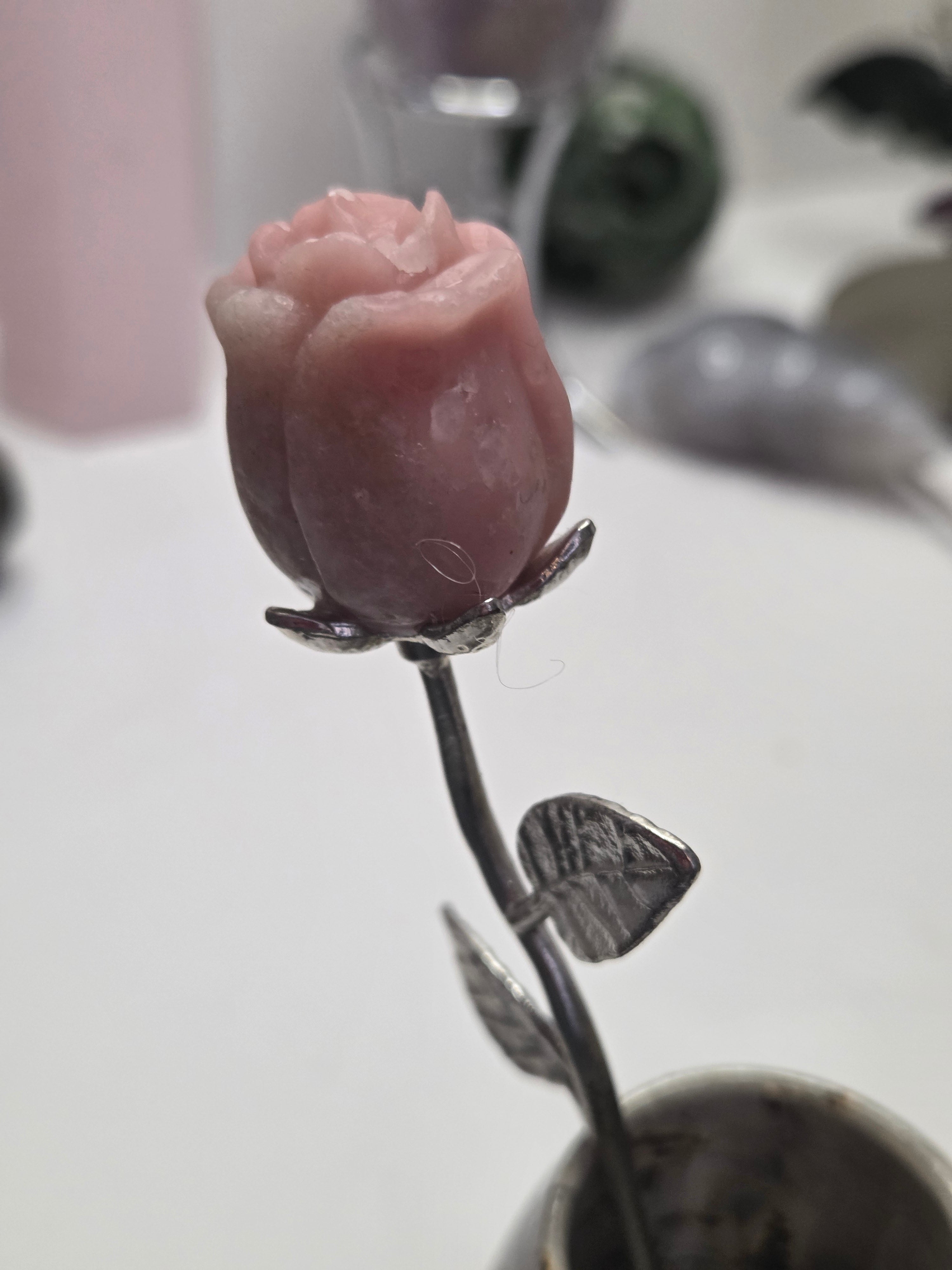 Pink opal crystal rose carving on a stem