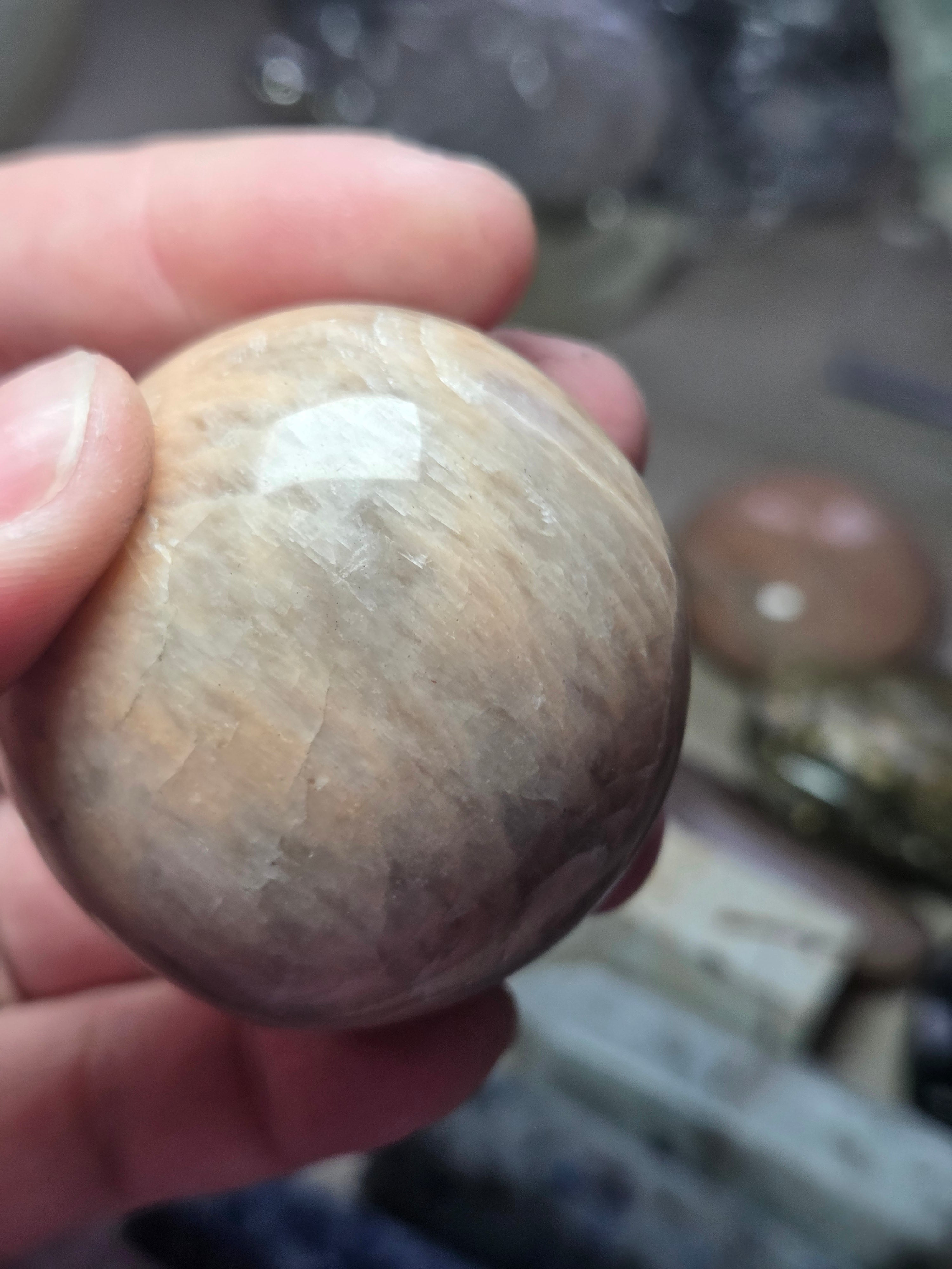 Peach moonstone crystal palm stone with imperfections