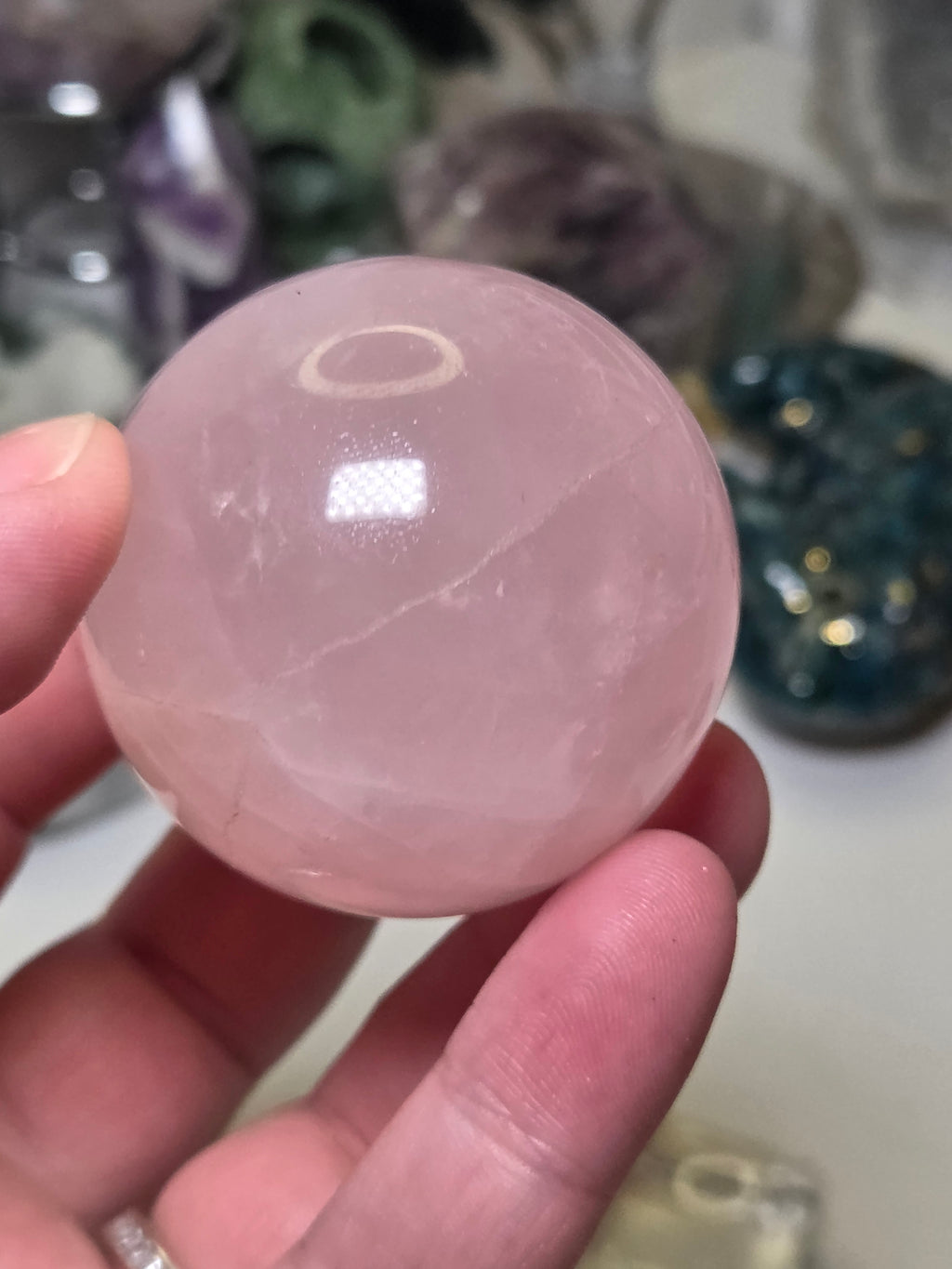 Rose quartz crystal sphere with  crack line and star flash