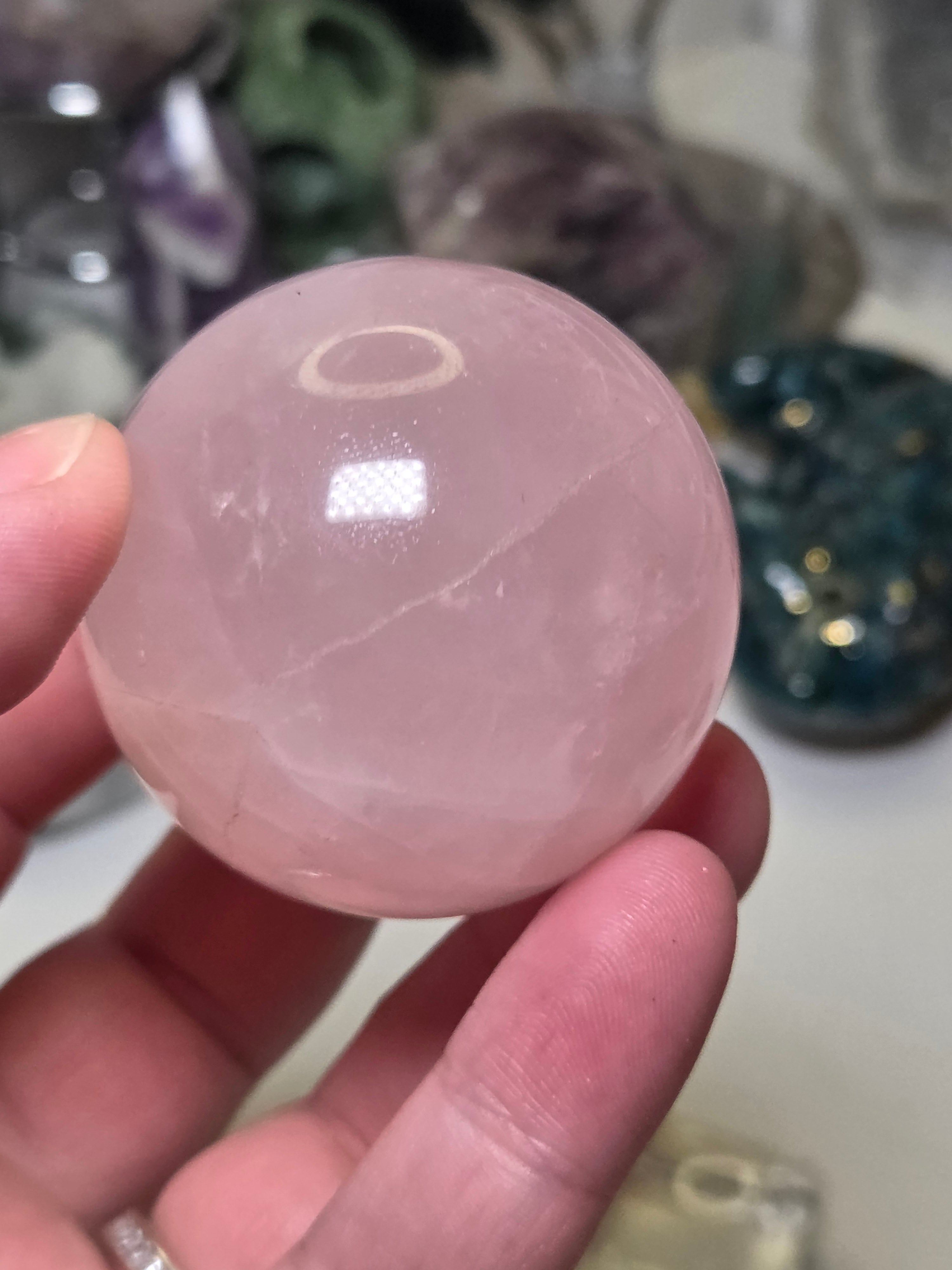 Rose quartz crystal sphere with  crack line and star flash