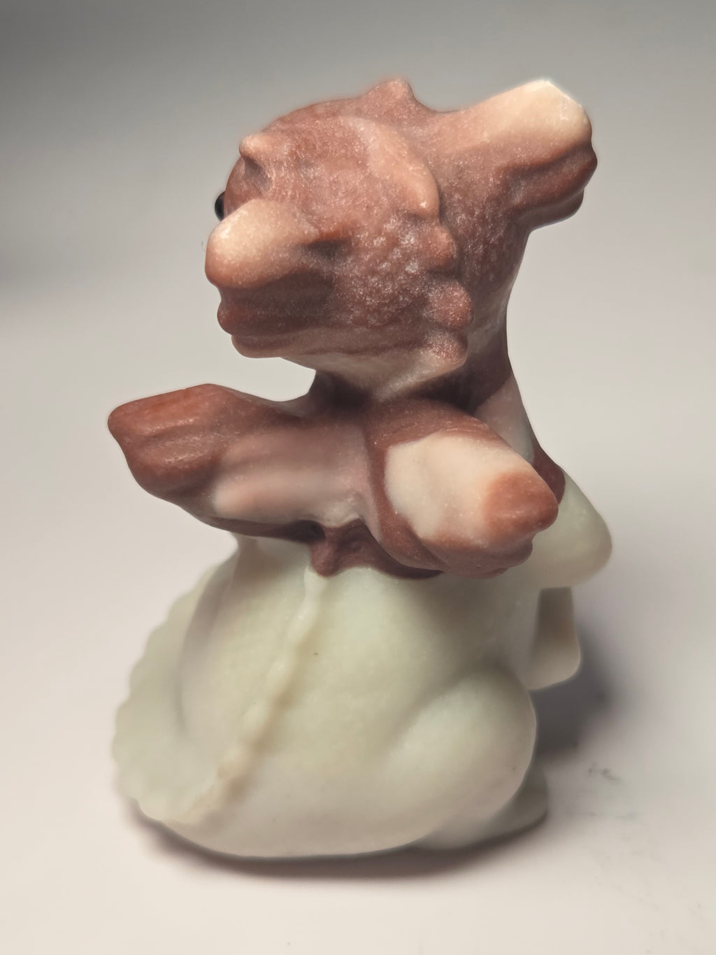 Baby dragon holding tail