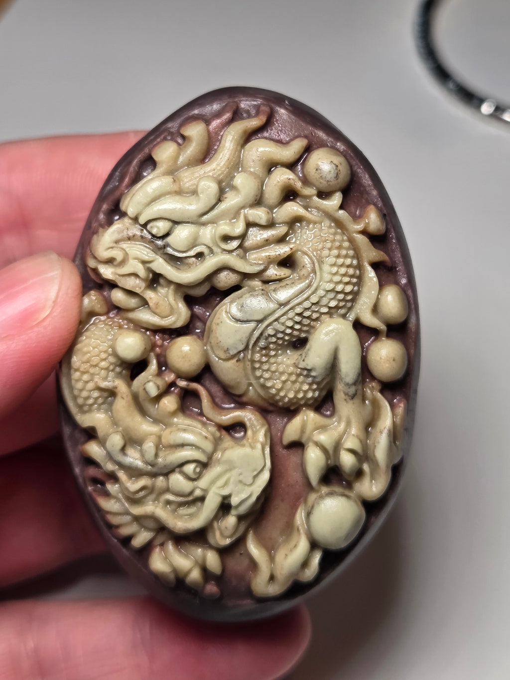 Handmade carved dragon palm stone in purple jade from Province