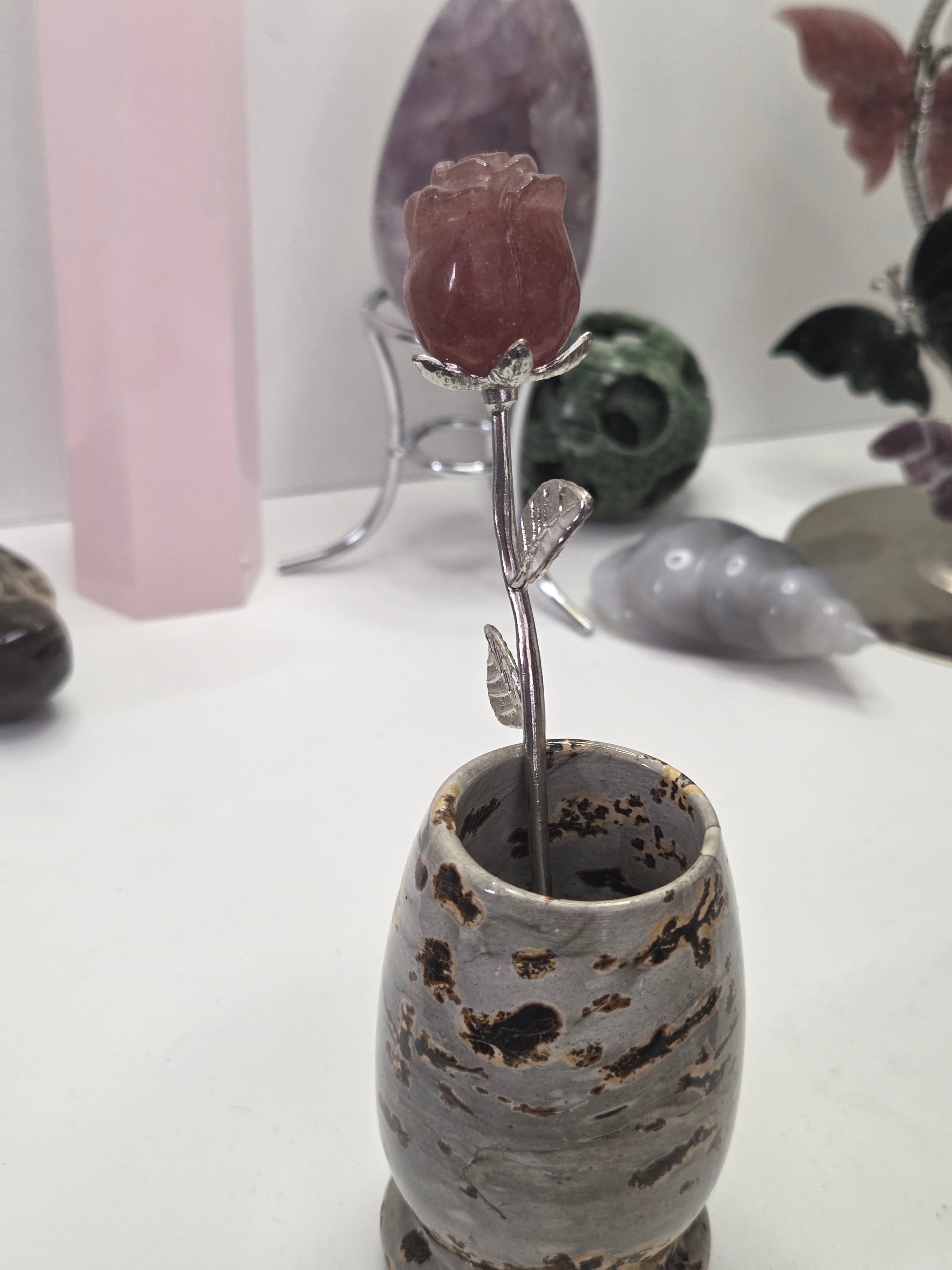 Strawberry quartz crystal rose carving on a stem