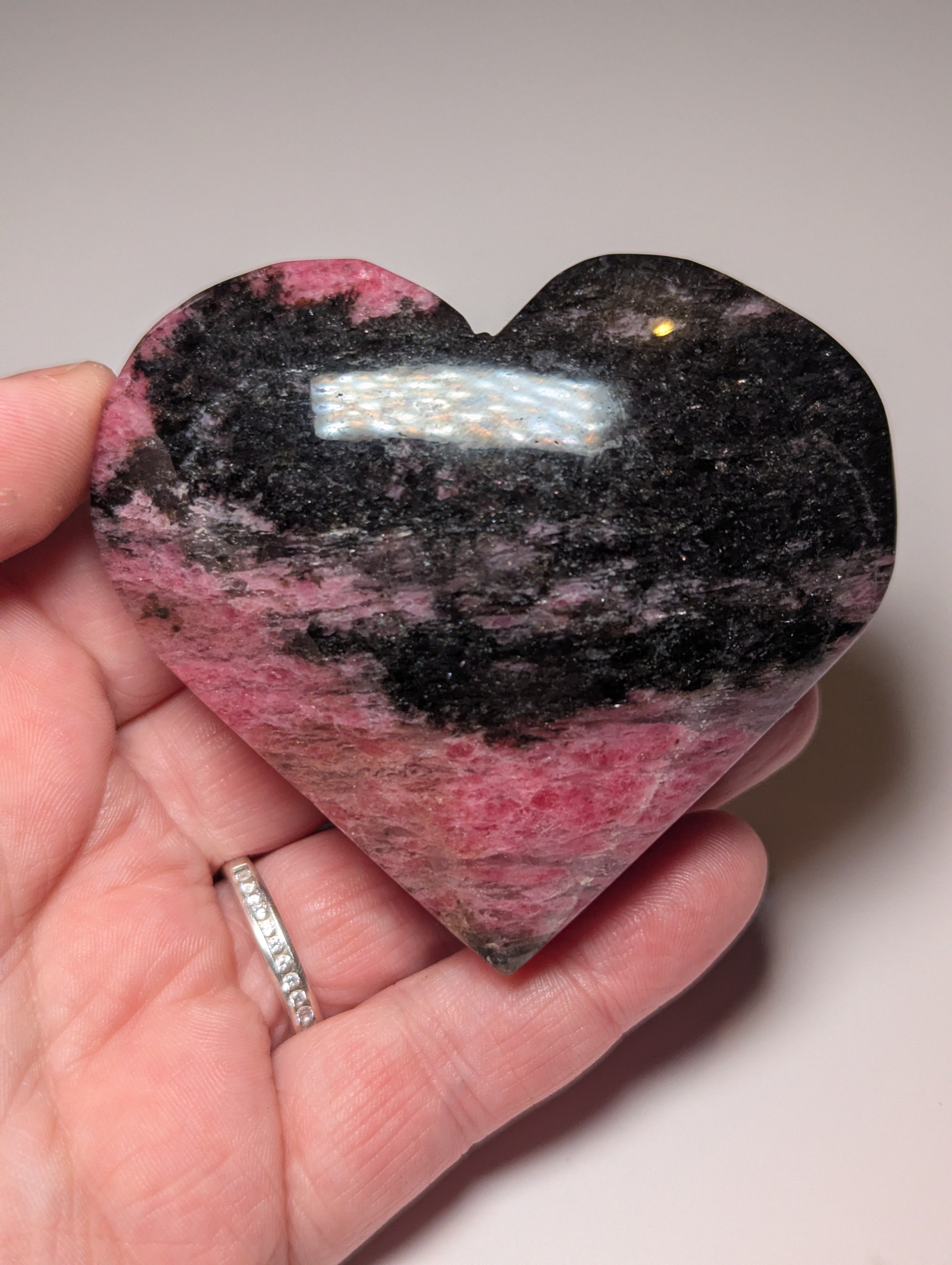 Large Rhodonite crystal heart carving with stand