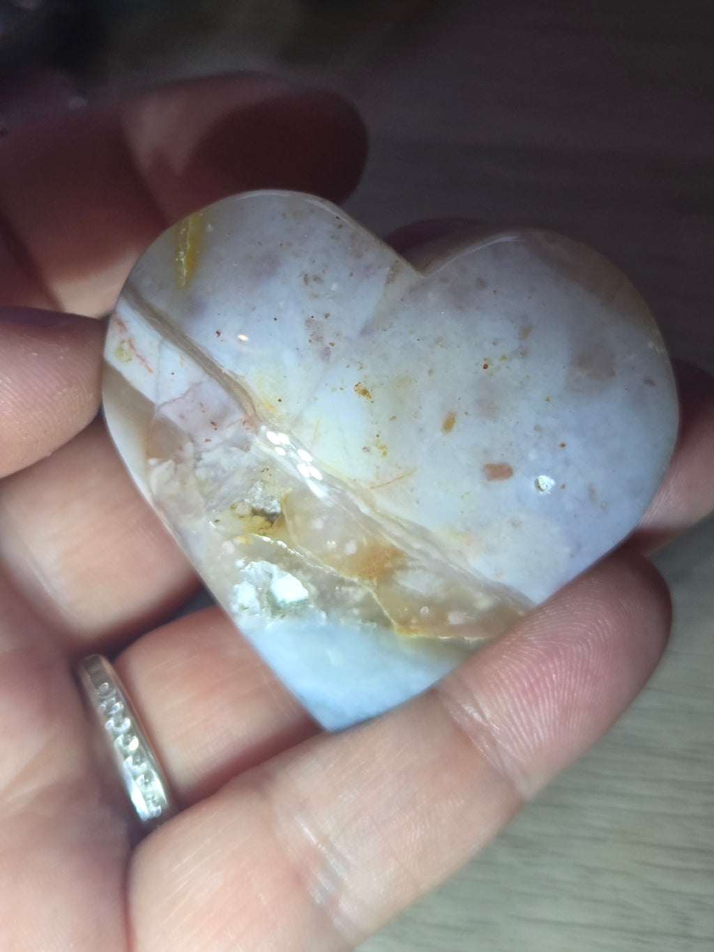 Pink petrified wood heart carving with UV