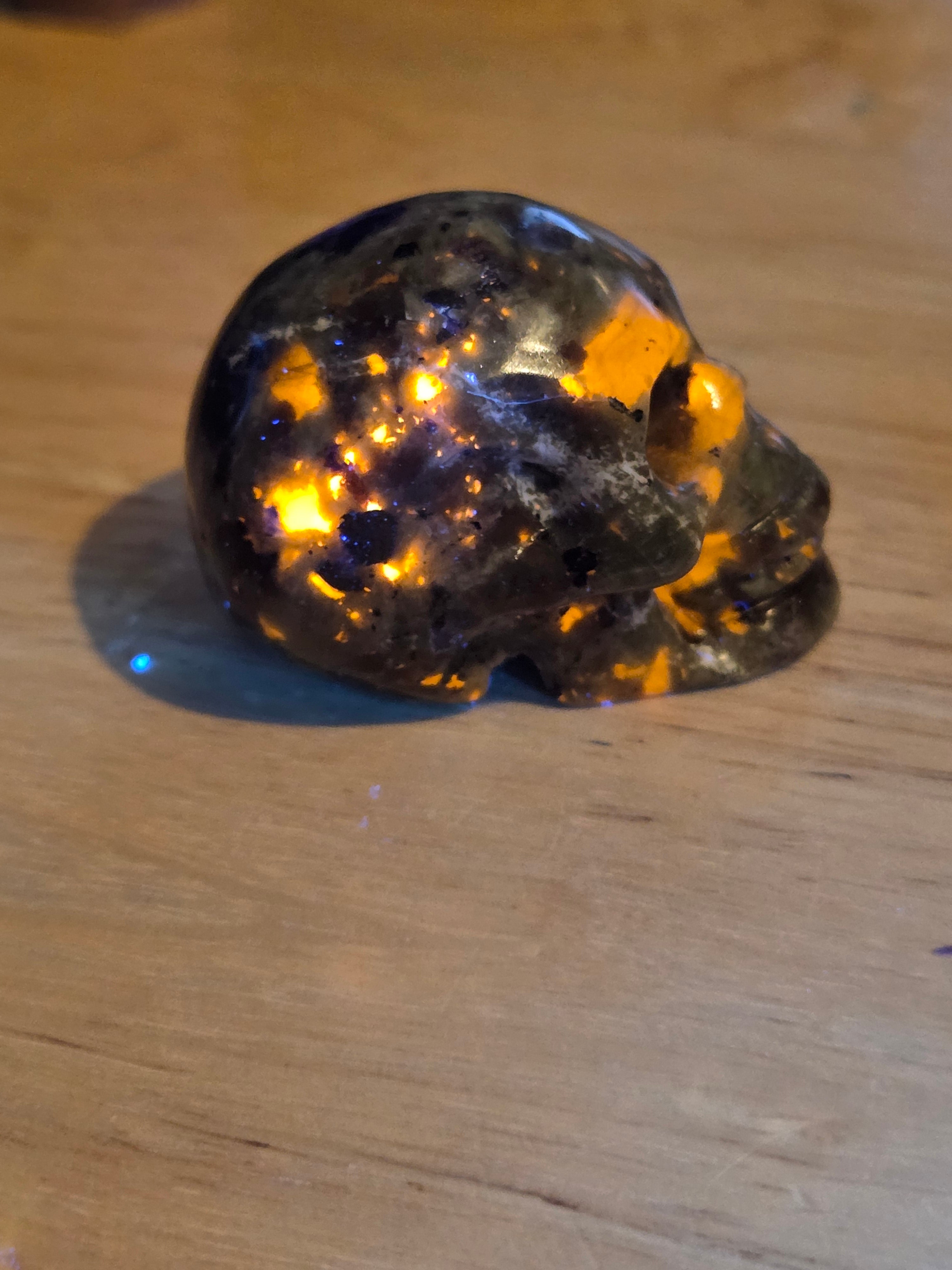Yooperlite crystal skull carving with orange uv