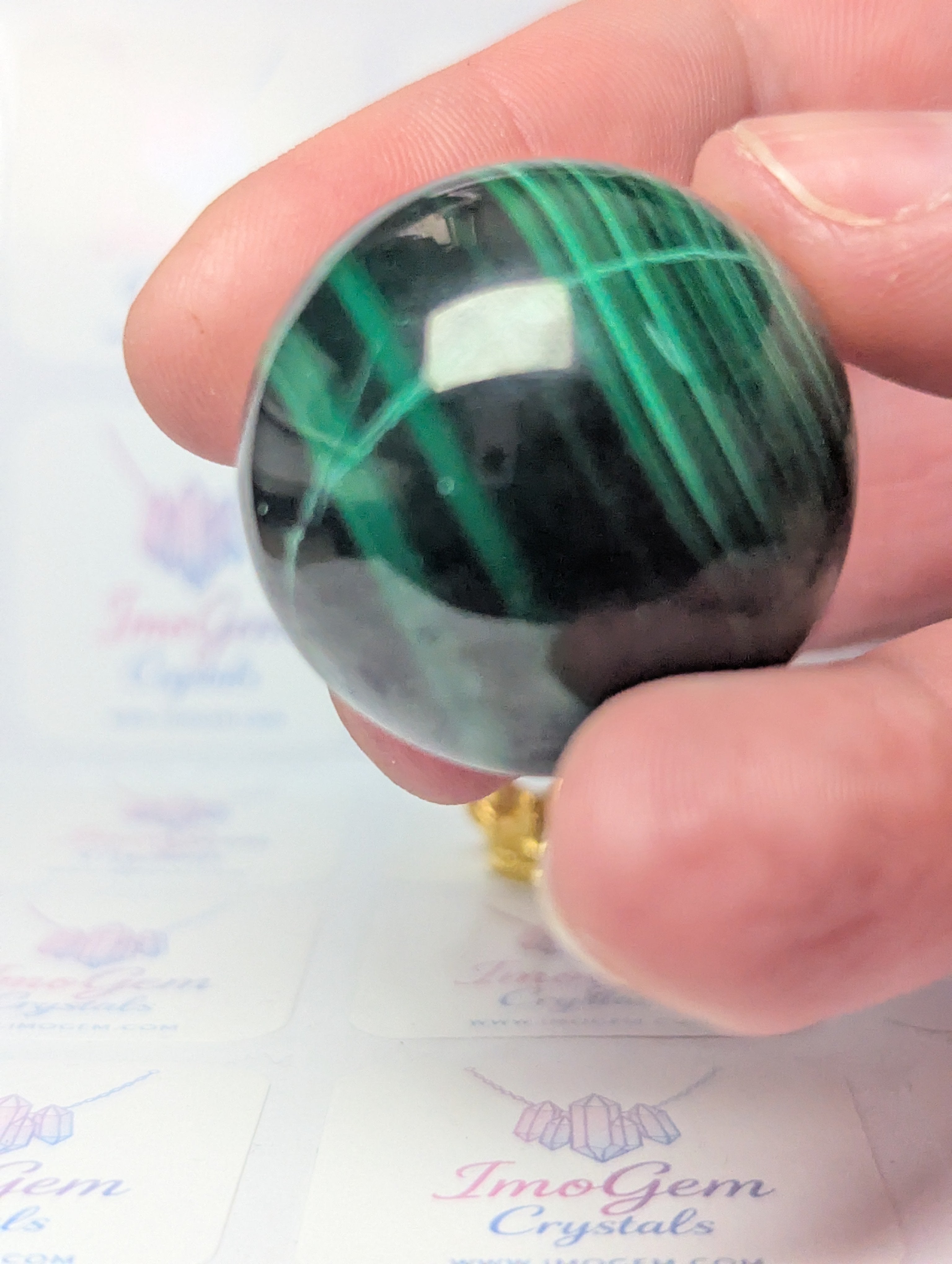 Malicite crystal sphere with imperfections